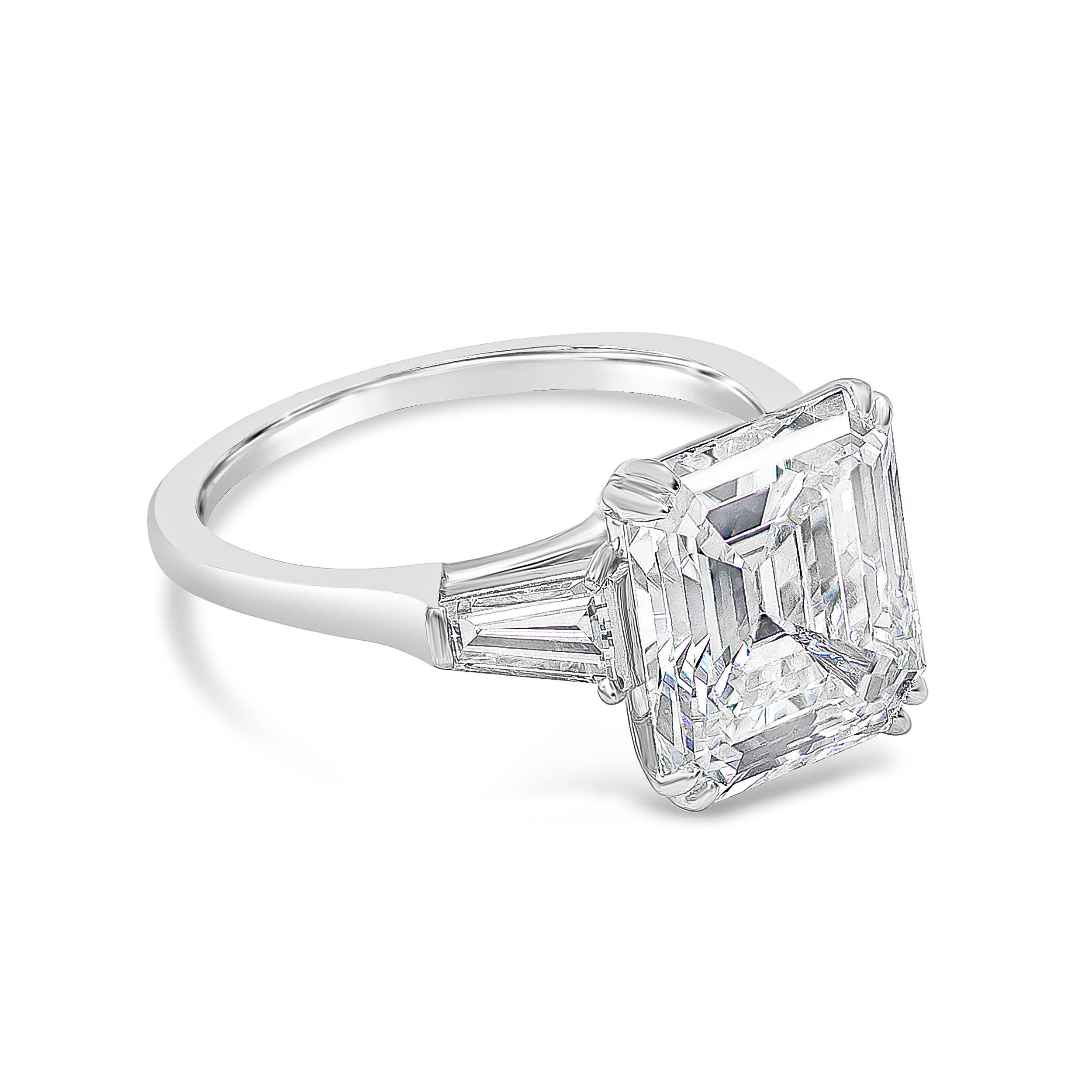 A classic Harry Winston engagement ring style showcasing a 4.01 carat emerald cut diamond certified by GIA as H color, VS1 clarity. Flanking the center diamond are two tapered baguette diamonds weighing 0.55 carats total. Set in a polished platinum