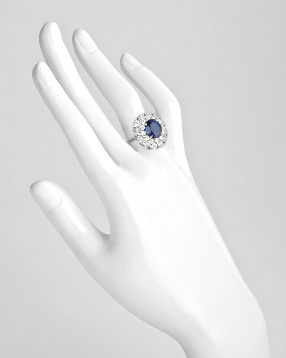 Burmese sapphire and diamond cluster ring, centering an oval-shaped 