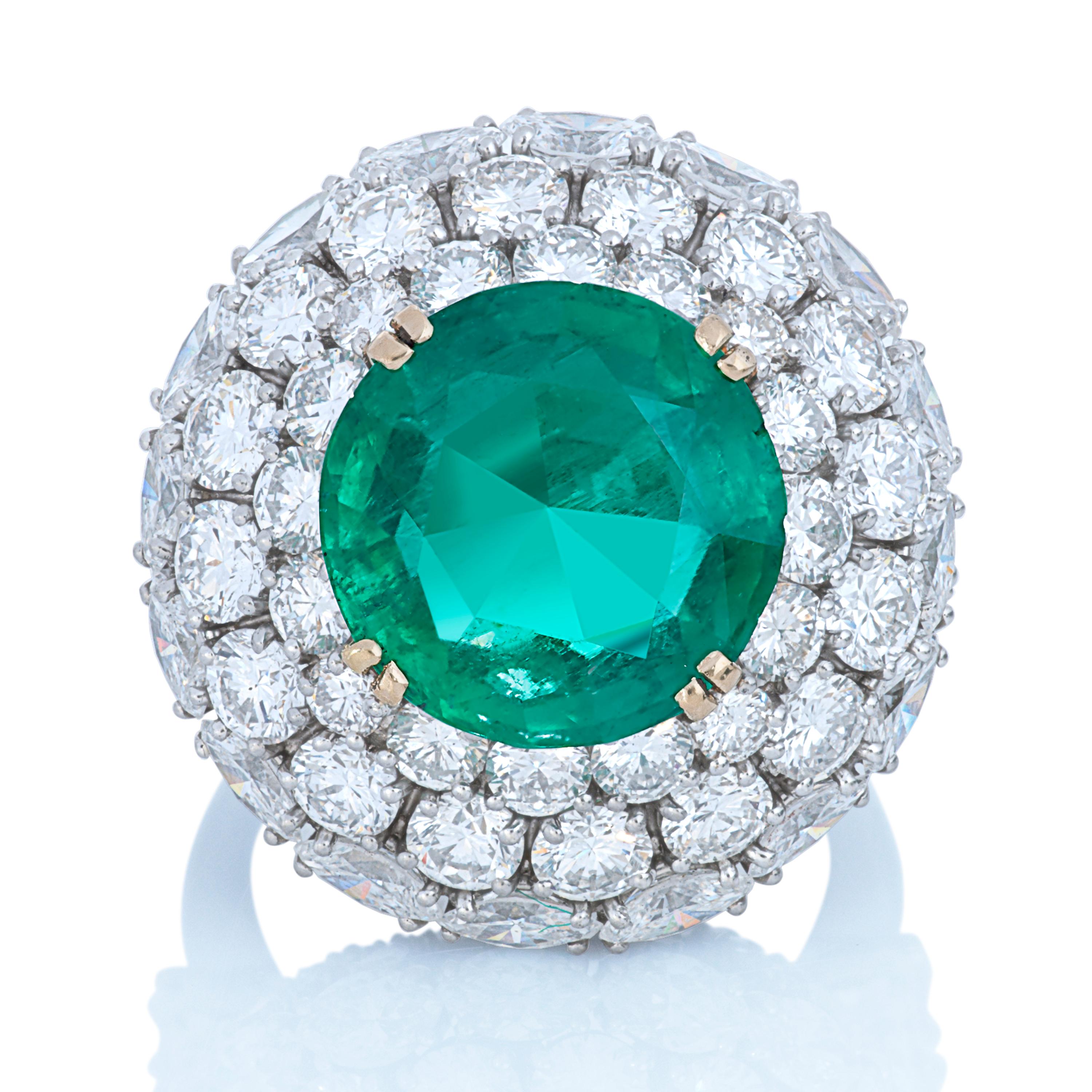Harry Winston Colombian emerald and diamond cocktail ring with a platinum setting and 18k yellow gold prongs.  

This Harry Winston ring features a 6.81 carat round Colombian emerald accompanied by an AGL report.  The emerald is surrounded by