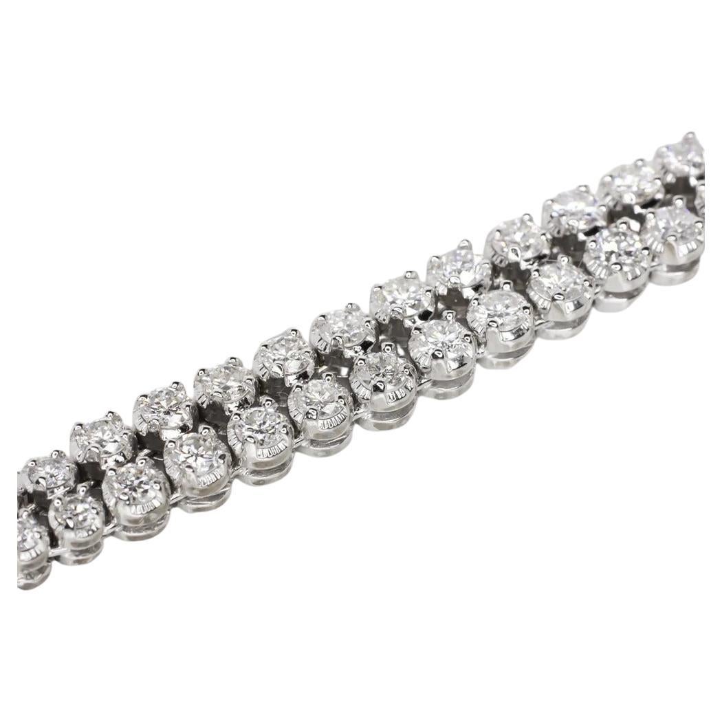 An exquisite bracelet signed Harry Winston

With 2 rows of round brilliant cut diamonds  

VVS/VS Clarity E/F Color exceptionally clean, the diamonds are the finest quality. They are set in hand perfected 18k white gold. This bracelet is the