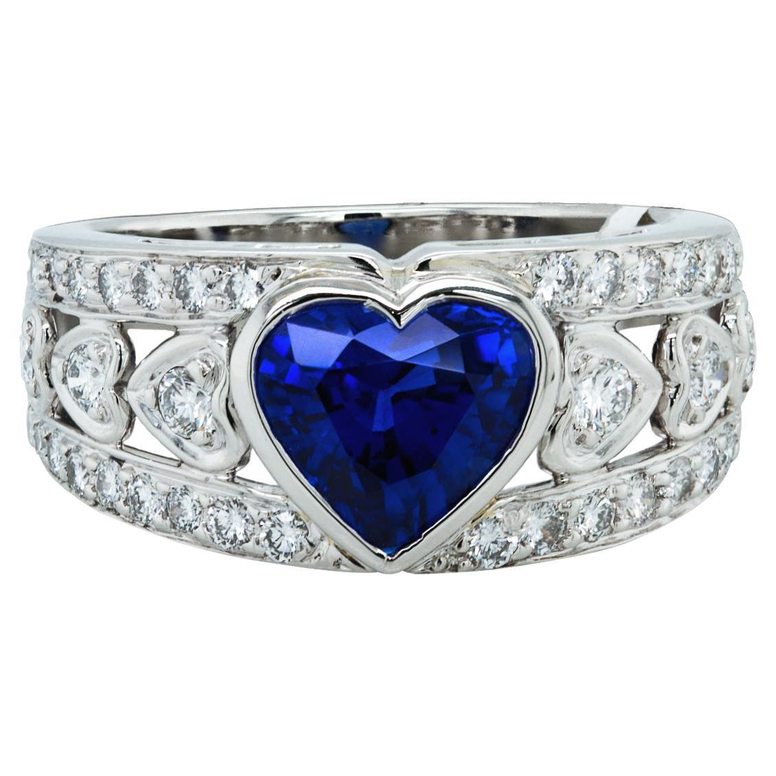 A beautiful cocktail ring embellished with a heart-shape sapphire weighing 2.65 carats.
The sapphire is accompanied by AGL report stating that it's of Madagascar origin with clarity enhancement.
Made by Harry Winston. Signed HW and stamped with the