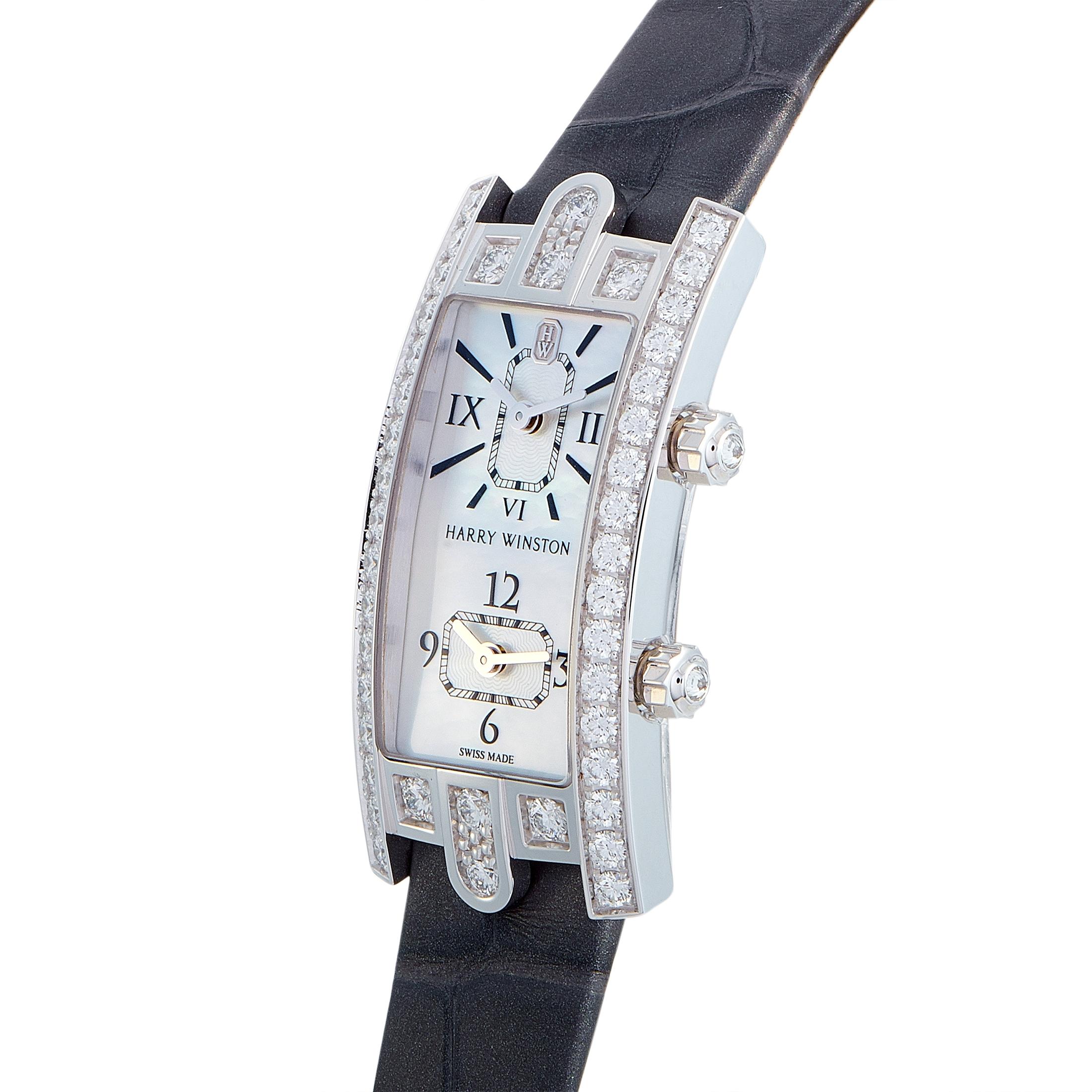 The Harry Winston Avenue C Dual Time, reference number AVECQTZWW007, is a member of the sublime “Avenue” collection.

The watch boasts a diamond-set 18K white gold case presented on a gray leather strap that is fitted with a deployment clasp. This