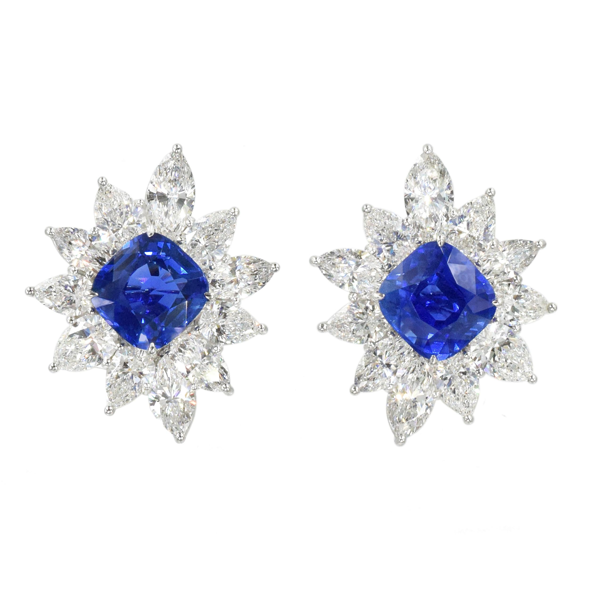 Harry Winston Sapphire and Diamond Ear clips in platinum and 18k
white gold. Each earring set in the center with a cushion cut sapphire. Framed by pear and marquise shaped diamonds with total weight of approximately 14.35 carats
Sapphires weighing