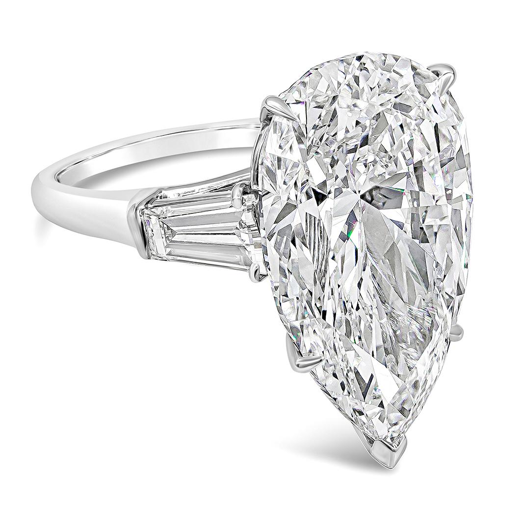 A classic Harry Winston diamond engagement ring showcasing a GIA certified 12.00 carat pear shape diamond, flanked by tapered baguette diamonds weighing 1.35 carats total. The ring is stamped by Jacques Timey which is well-renowned maker of Harry