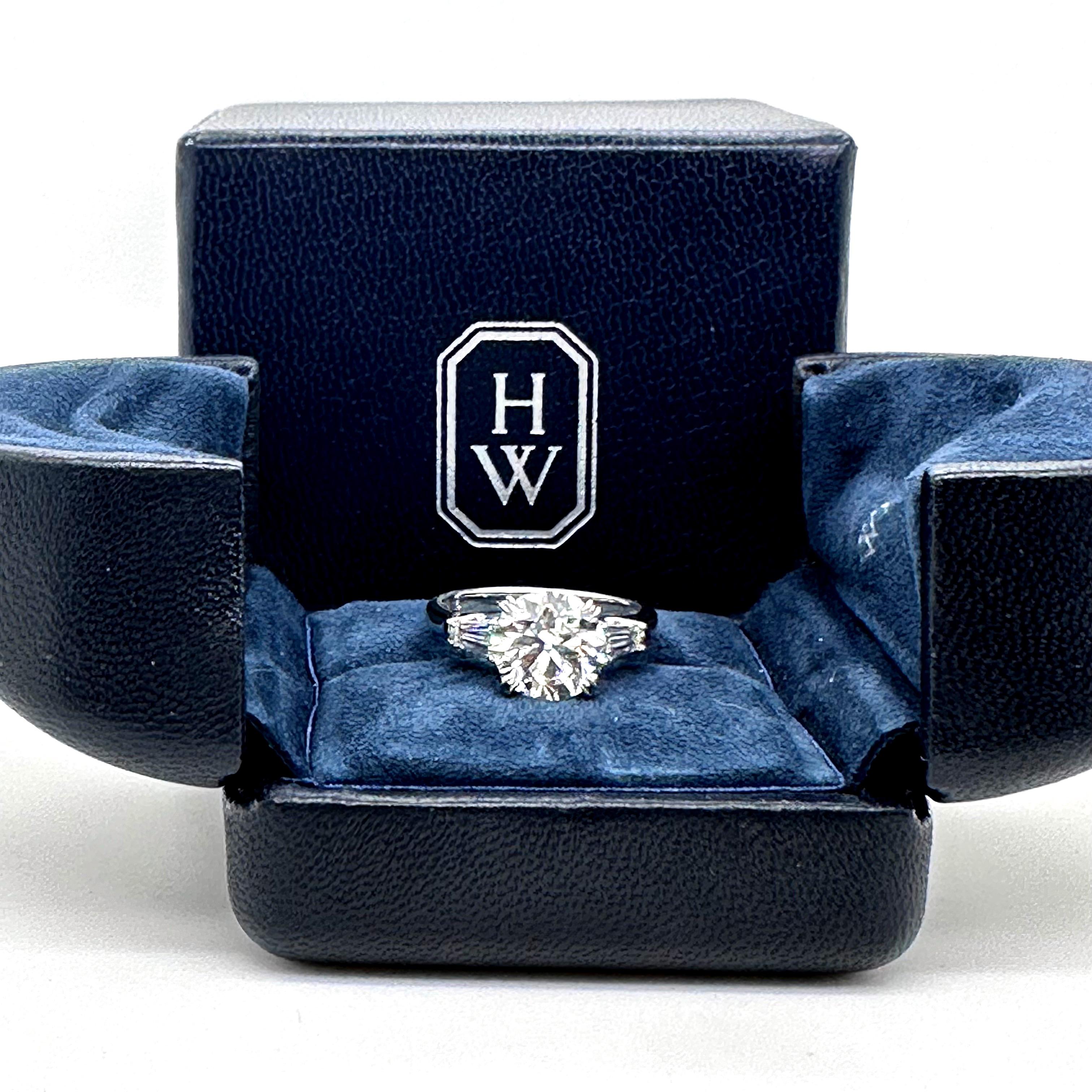 classic winston round brilliant engagement ring with tapered baguette side stones