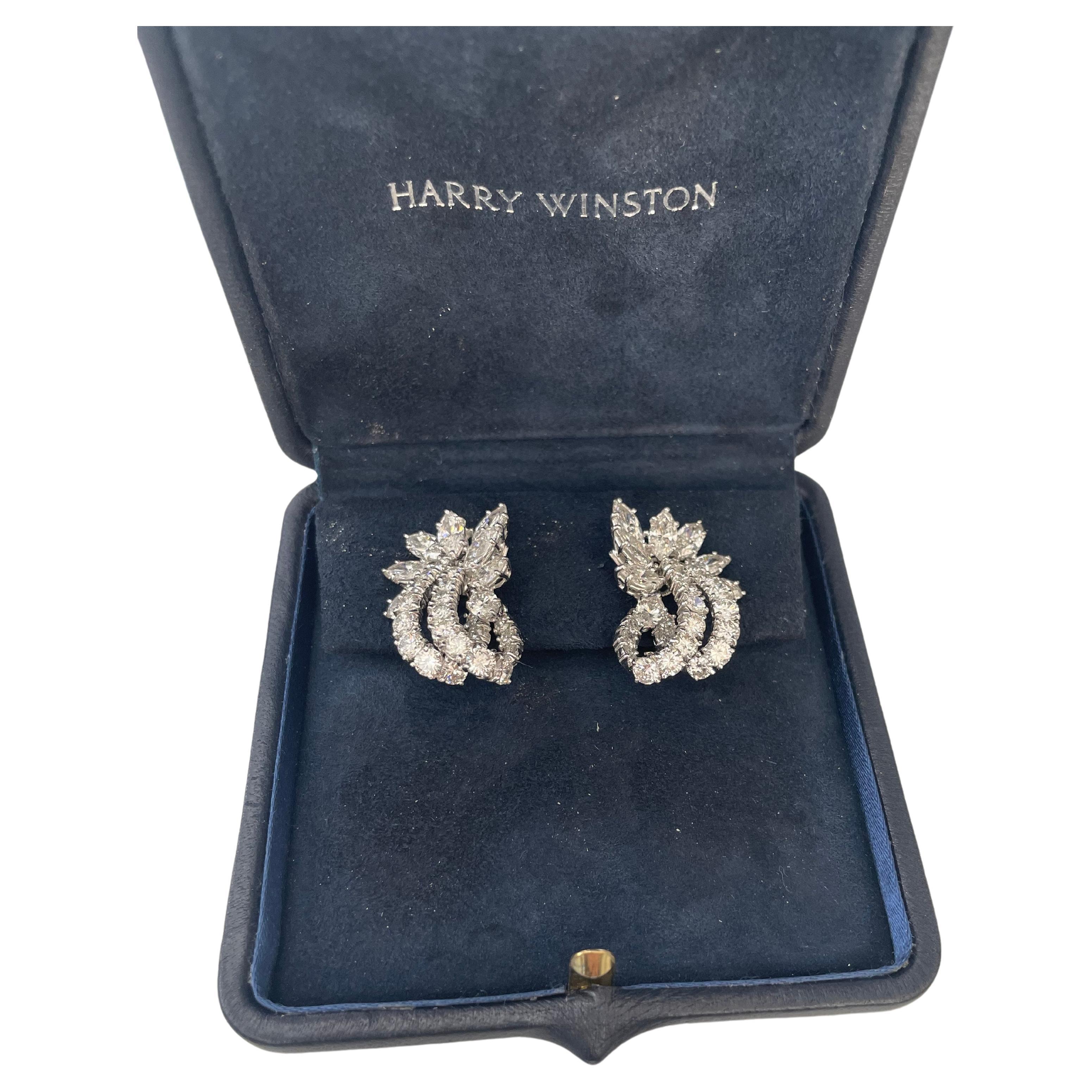 Harry Winston  (Jacque Timey) Diamond Earrings 
This pair of earrings
has 16 marquise shaped diamond clusters weighing
5.40ct (Color: D-F, Clarity: VS) each suspending a pair of graduated diamond set hoops set with 4 round brilliant-cut diamonds