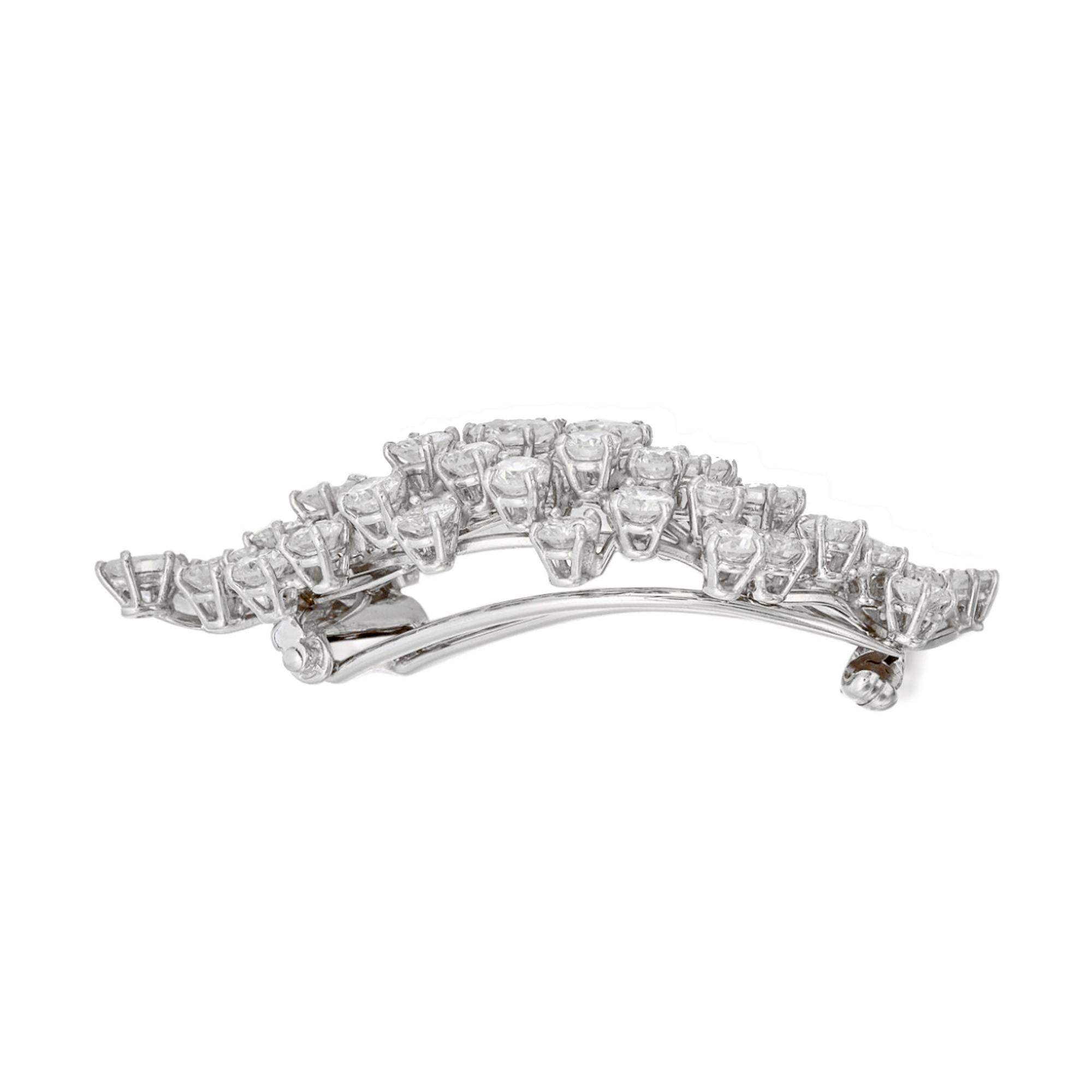 Discover the timeless elegance of the Harry Winston Cluster Vintage Platinum Diamond Brooch, a versatile masterpiece that doubles as a necklace, hailing from the esteemed year of 1975. This exquisite piece encapsulates the unmatched craftsmanship