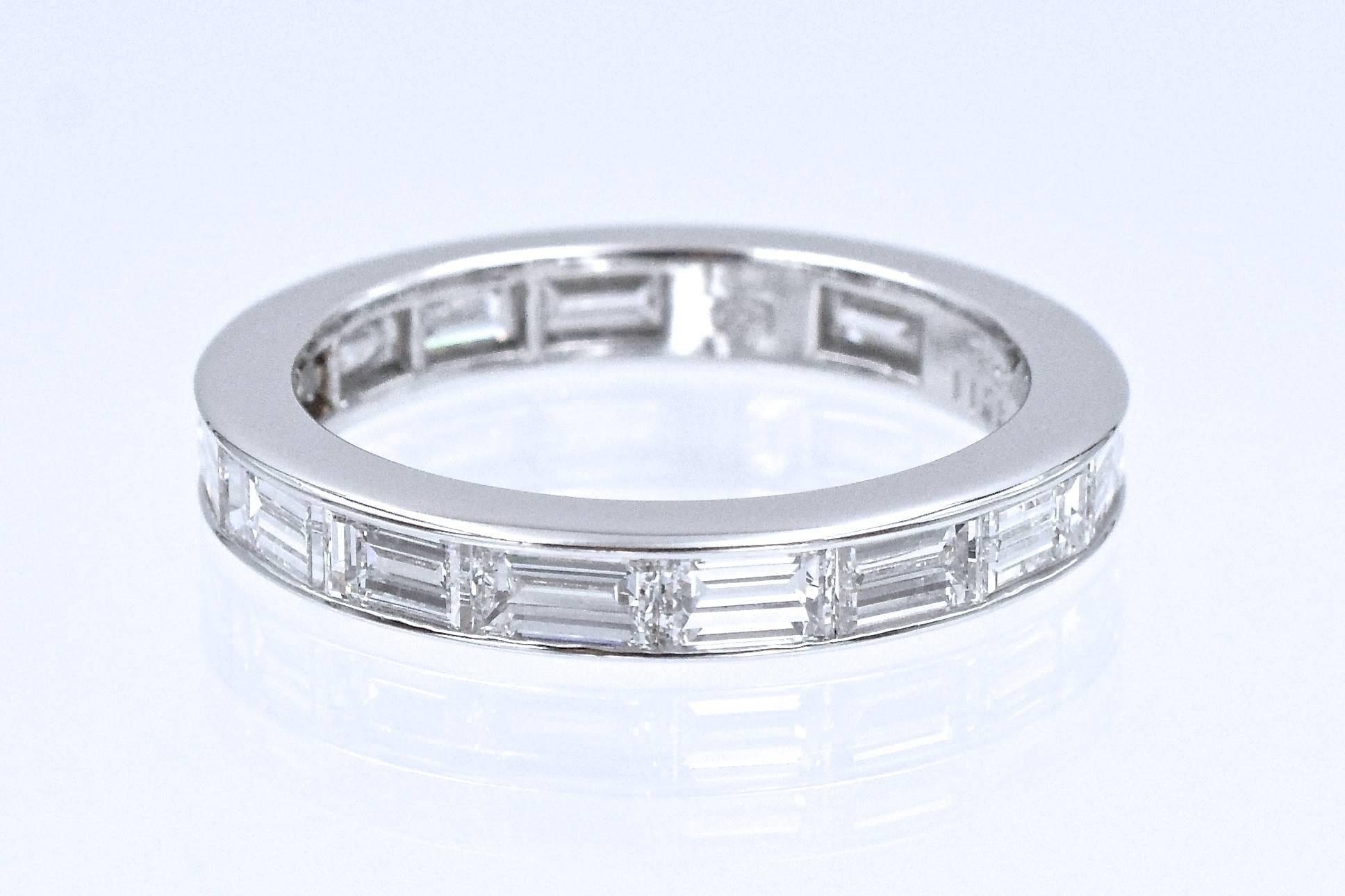 Elegant & Timeless diamond eternity band by Harry Winston. This band has 16 emerald cut diamonds set in platinum with channel style Total weight of the diamonds is 3 carats, F color VS clarity. Signed HW, Stamped PT950, and numbered Ring Size: 7.5