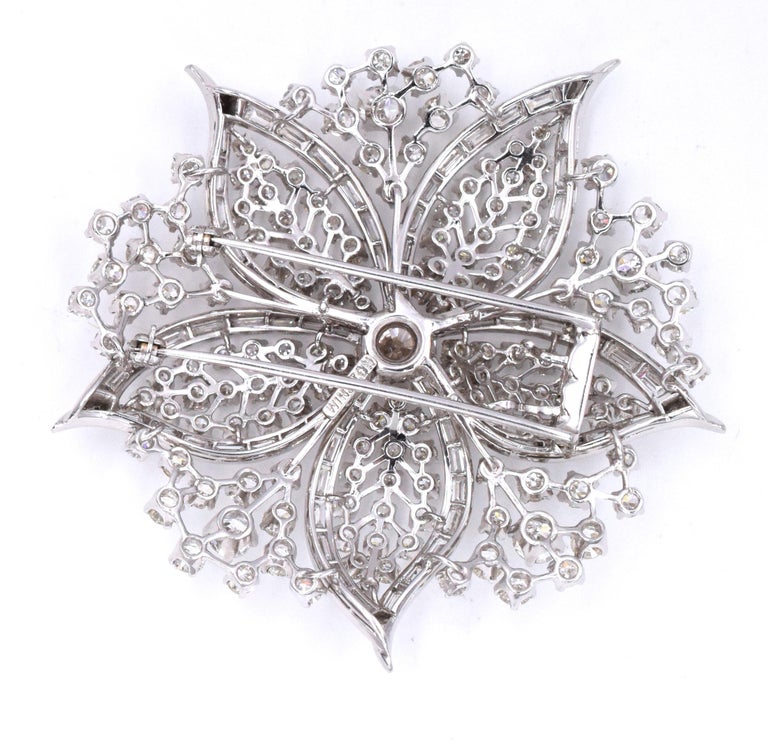 Harry Winston Diamond Flower brooch. This brooch has about 230 diamonds, including the center stone, weighting approximately 20carats , all set in platinum The center diamond is about 1.50carats.
 Signed Winston. 
Measurements: about 2.25 inches by
