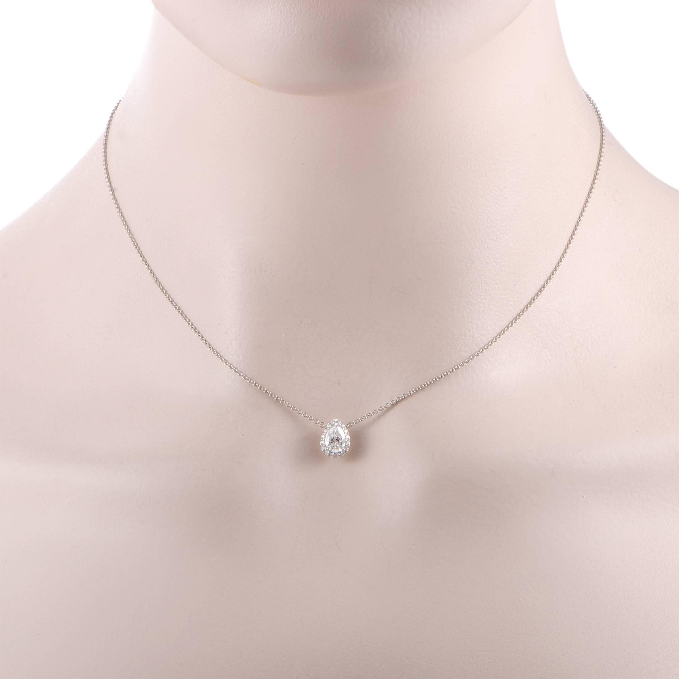 An epitome of refined elegance, this sublime platinum necklace offers a splendidly classy appearance. Designed by Harry Winston, the necklace features a pendant that is set with a majestic center diamond stone of D color and VVS1 clarity weighing