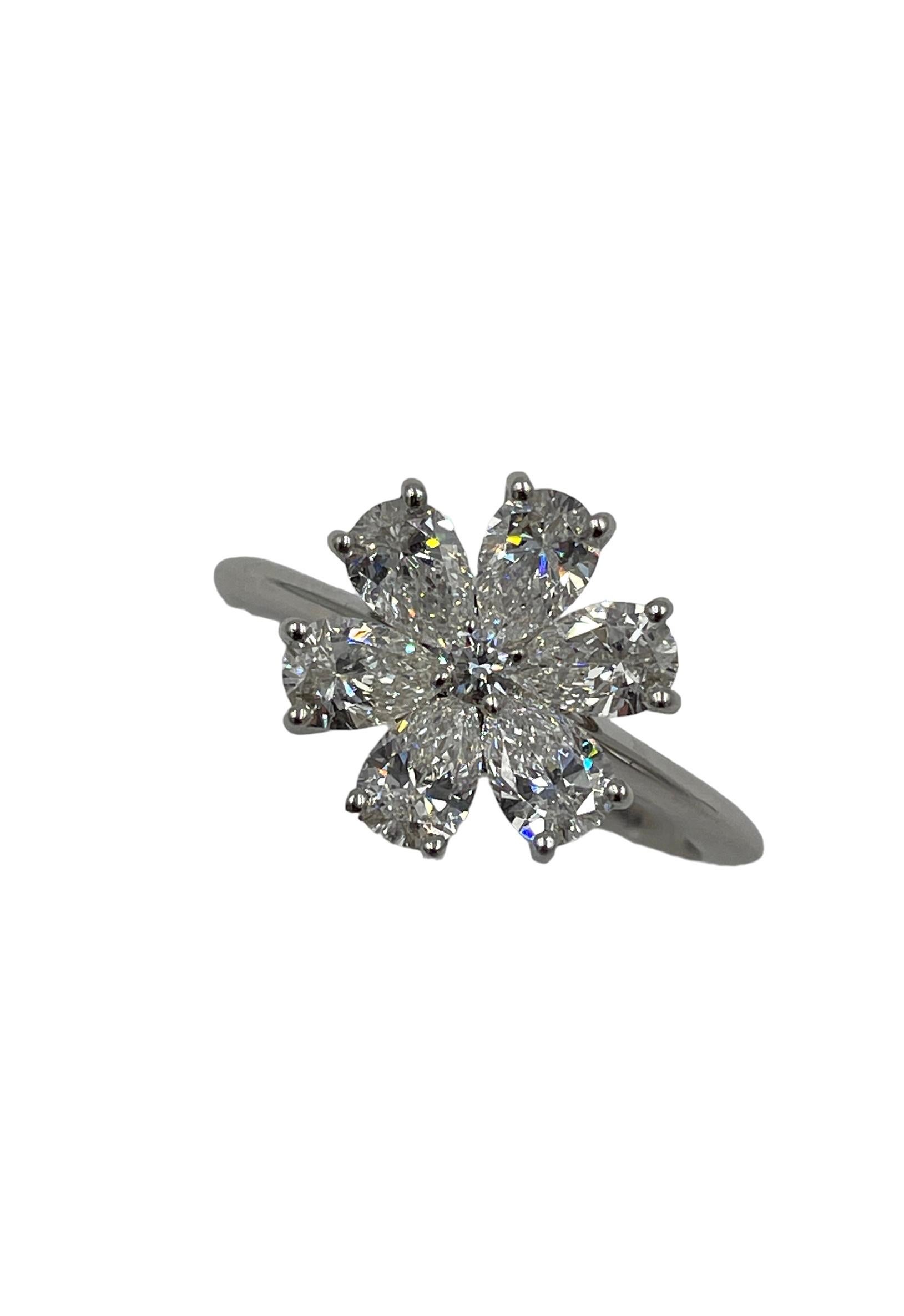 Harry Winston diamond platinum ring.  This is the Forget-Me-Knot diamond cluster ring.  Set with 6 pear-shaped and 1 round brilliant diamond, weighing a total of approximately 1.66 carats (approximately VVS-VS clarity, F-G color), set in