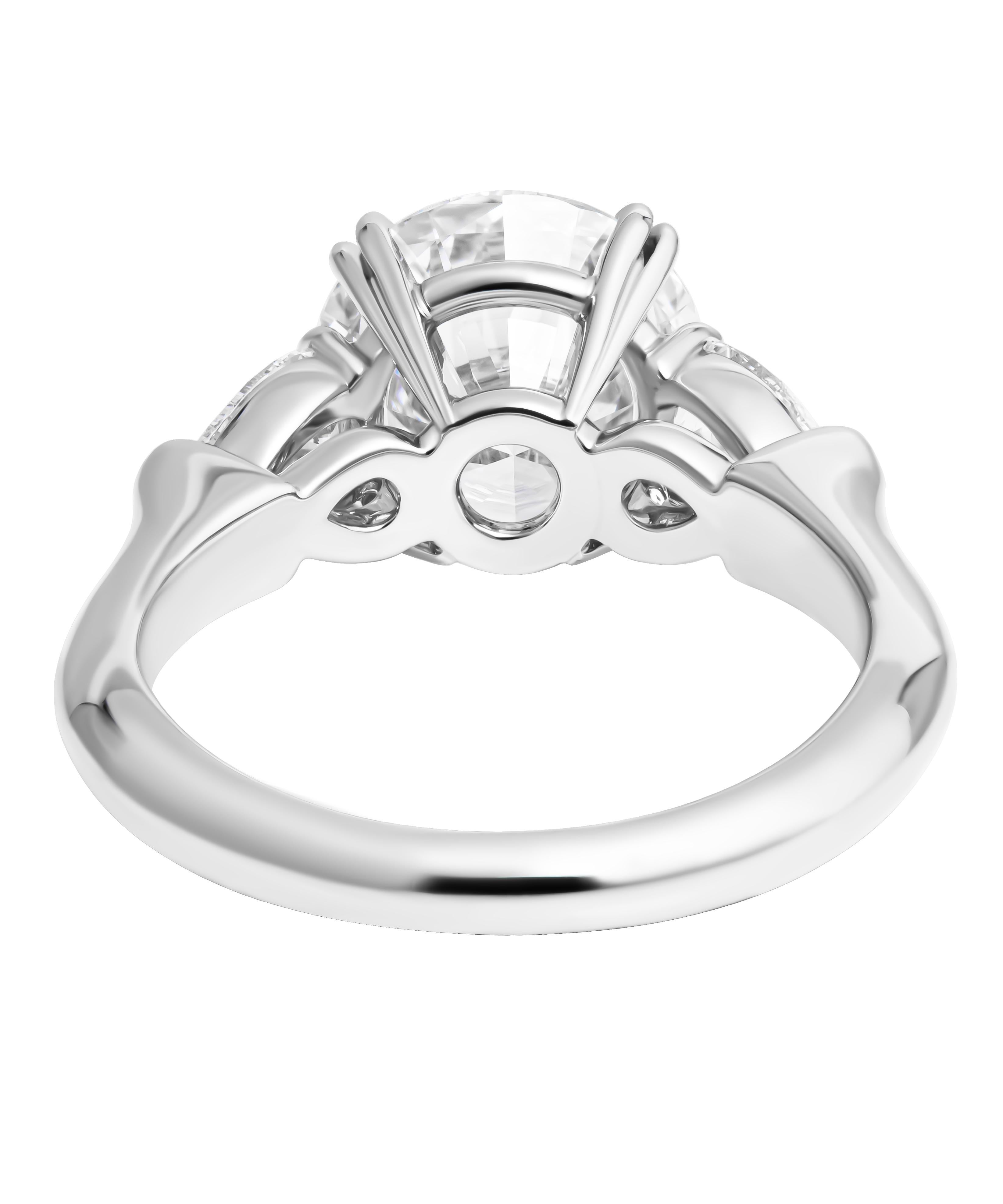 Harry Winston Engagement Ring with 3.02ct E VVS1 Round
In Platinum
with original hallmark , size 6
Center Stone is 3.02ct E VVS1 GIA#14661653
with 2 pear shapes D/E color & VVS clarity aprox. 0.70tcw