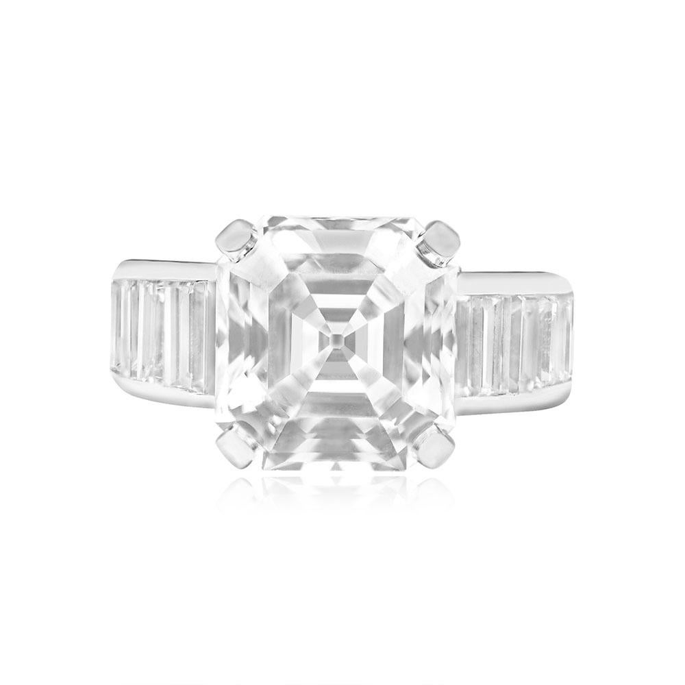 Sophisticated Harry Winston engagement ring showcasing a GIA-certified, prong-set Asscher cut diamond weighing 6.20 carats (E color, VS1 clarity). The entire length of the shank is adorned with baguette-cut diamonds, totaling approximately 3.50