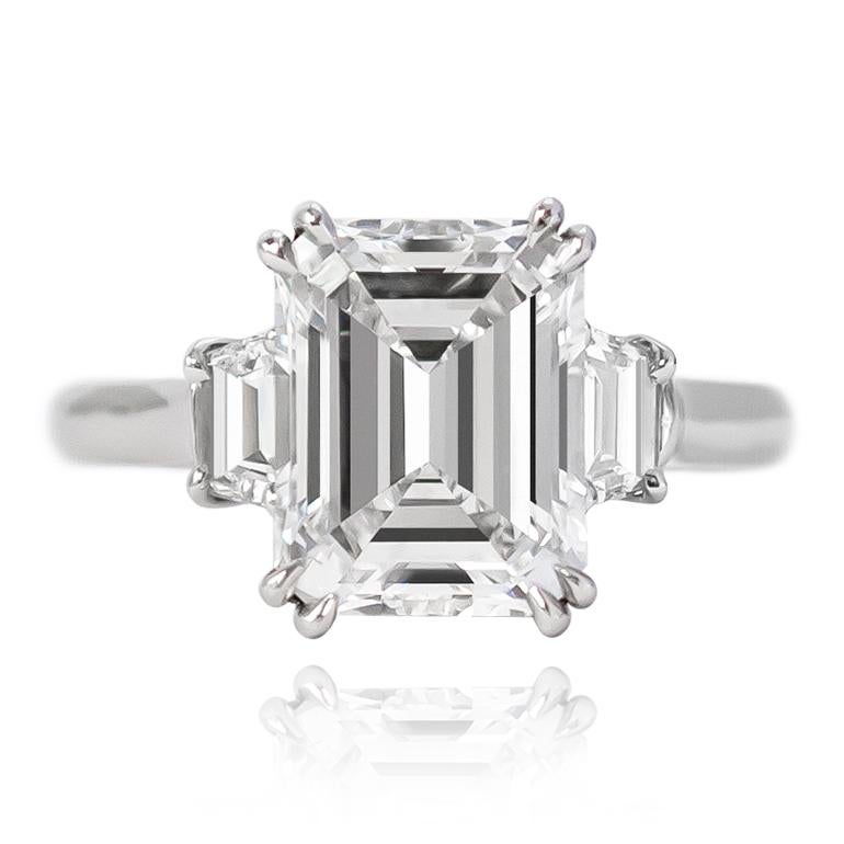 This breathtaking classic from the house of Harry Winston features a GIA certified 3.16 ct Emerald cut diamond of D color and VS1 clarity. Set in a signed, platinum mounting with step-cut trapezoid side stones of D / F color and VS2+ clarity, this