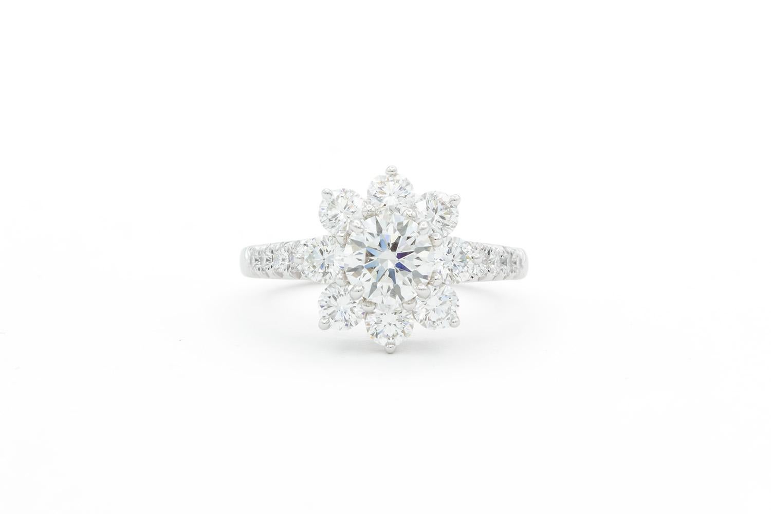 We are pleased to offer this Harry Winston GIA Certified Sunflower Ring. This beautiful and fun Harry Winston ring features a GIA certified 0.70ct F/VVS2 triple excellent round brilliant cut center diamond set in a Harry Winston platinum Sunflower