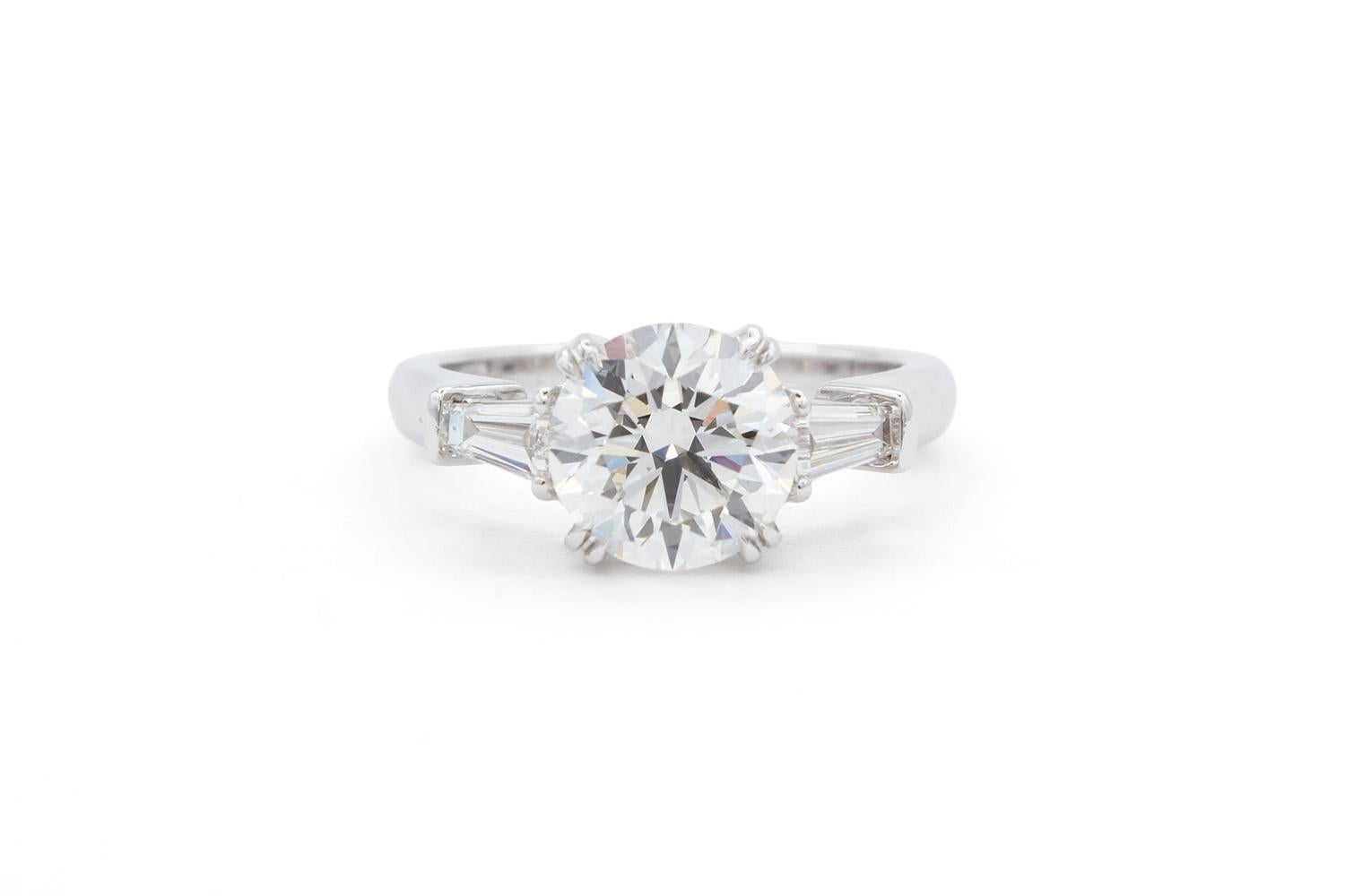We are pleased to offer this Harry Winston GIA Certified Three Stone Platinum Diamond Engagement Ring. This beautiful classic Harry Winston ring features a GIA certified 1.90ct F/VS1 triple excellent round brilliant cut diamond set in a Harry