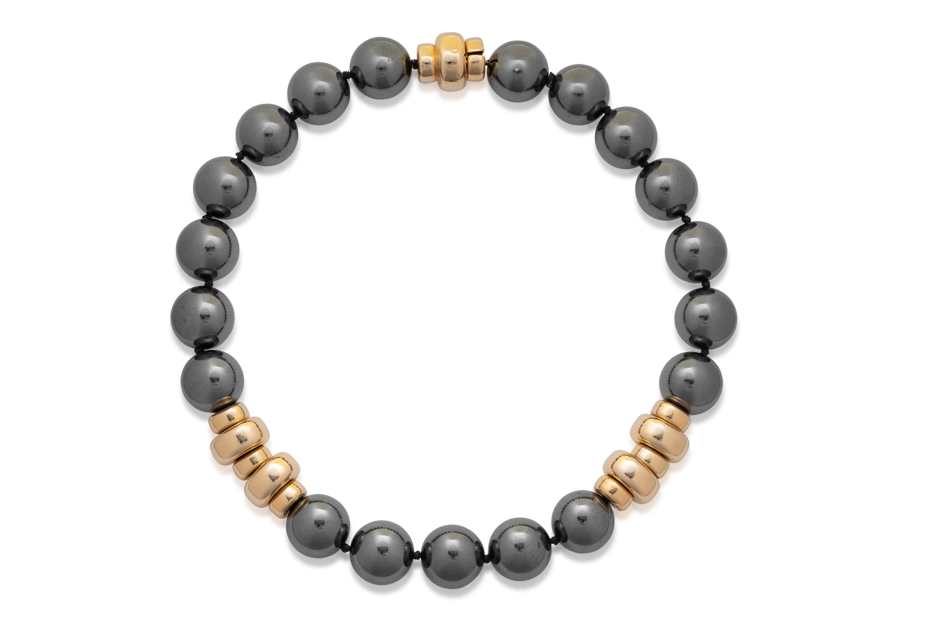 Exceptionally fine and rare Harry Winston hematite necklace with a gold clasp. It features hematite beads of 20mm in diameter. This necklace is further accented by a beautiful gold clasp figure. 
HEMATITE AND GOLD EARRINGS, HARRY WINSTON; cabochons