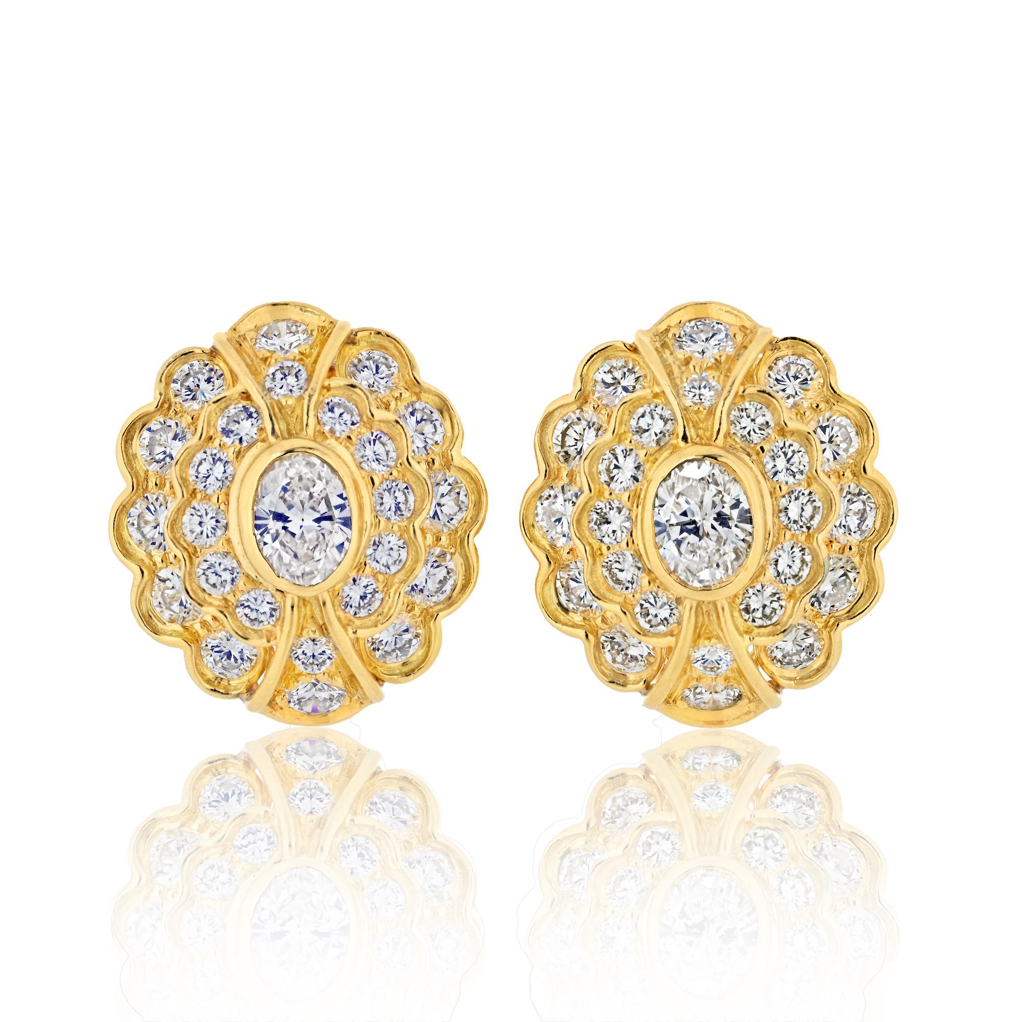 Harry Winston by Jacques Timey
Diamond ear clips in 18k yellow gold. Center of the earrings is bezel set with two oval cut diamonds with total weight of approximately 0.95ct., surrounded by  48 fine quality round brilliant cut diamonds with total