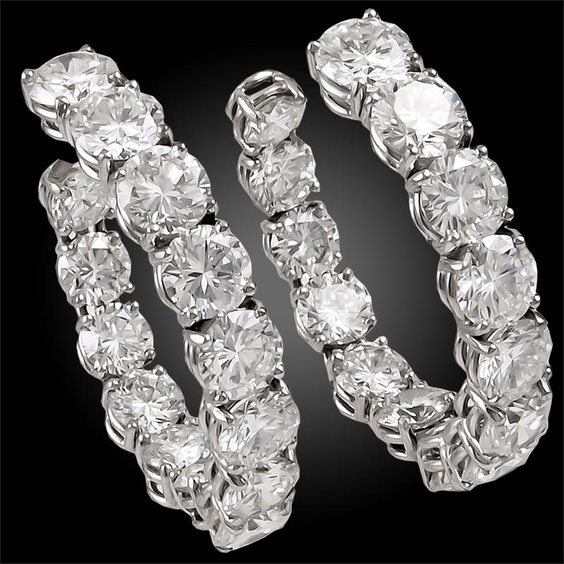 Harry Winston Jacques Timey Diamond Hoop Earrings
A vintage pair of ‘inside out’ hoop earrings by Harry Winston with a row of round brilliant diamonds on the front as well as the inside hoop. The gems are set in a slightly torqued platinum setting –