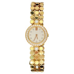 Harry Winston Lady's Watch in 18K Yellow Gold and Diamonds.