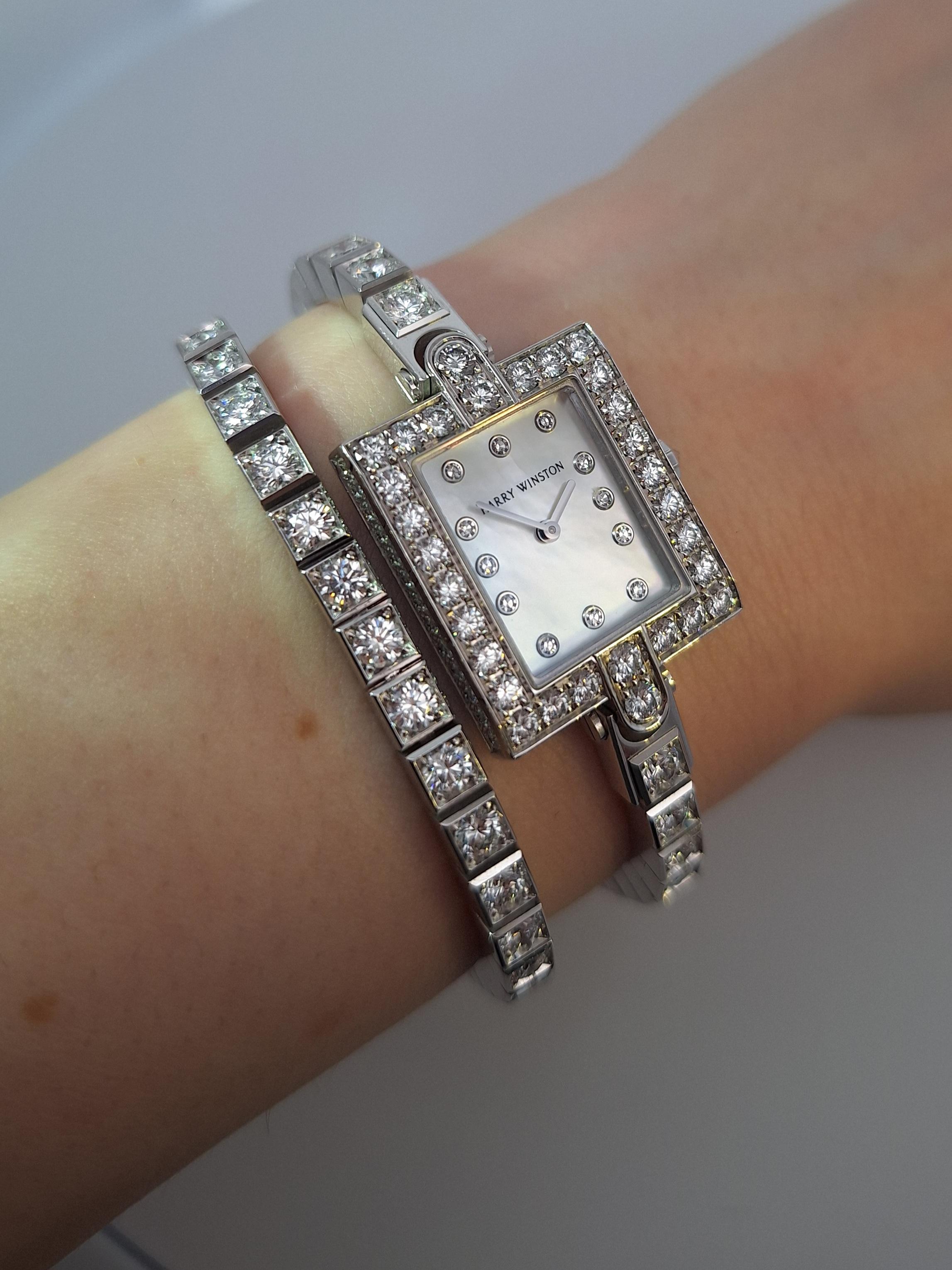 Timeless elegant piece, crafted in 18K white gold with mother of pearl dial, round brilliant cut diamonds weighing approximately 12 carats, F-G color/VS clarity.

Bracelet may be shortened and detachable portion can be worn on its own or you can