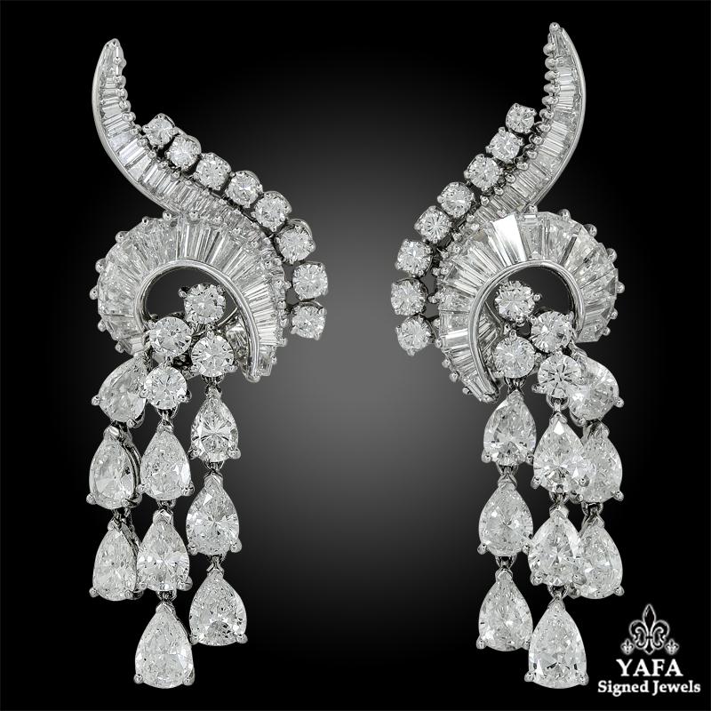 A pair of chandelier ear clips, set with different shapes of brilliant-cut diamonds, mounted in platinum.
Total diamond weight approx. 12 cts E-F color & VVS-VS clarity; Measures approx. 2″ in length by 1″ in width
Stamped “Jacques Timey” hallmarks;