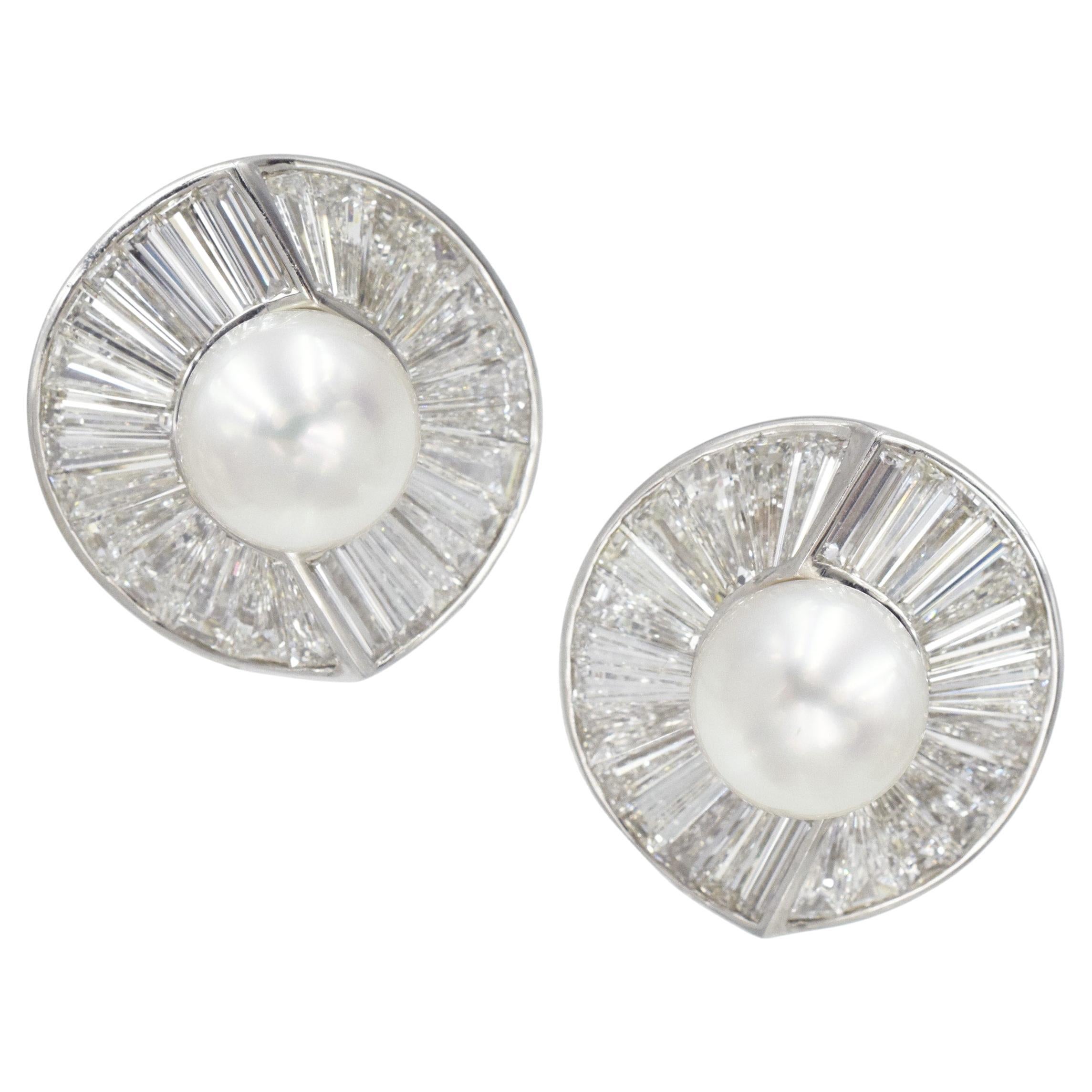 Vintage Harry Winston Pearl and Diamond Clip-On Earrings In Platinum. Circa 1960's. The earrings feature circular design, set in the center with total of two 12mm white cultured pearls. Surrounded by 56 tapered baguettes
with total weight of