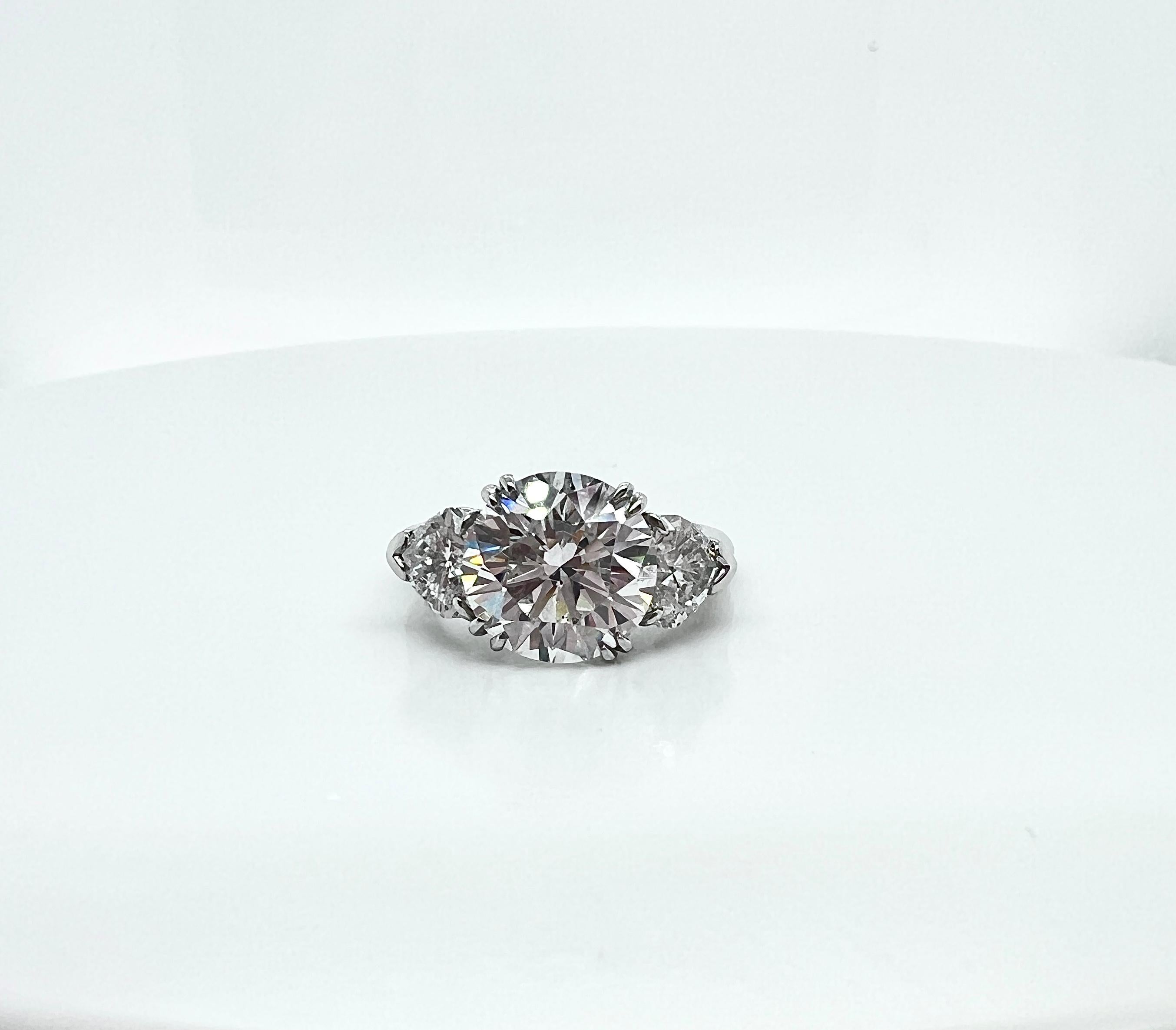 Harry Winston platinum RBC diamond engagement ring with GIA certificate
center diamond 4.05 cts E color SI1, with 2 heart shape diamond approx 1.50 cts
Marked HW PT 950 4.05
ring size: 3.75 to 4.5 (w/ring guard) 
Weight: 7.10g