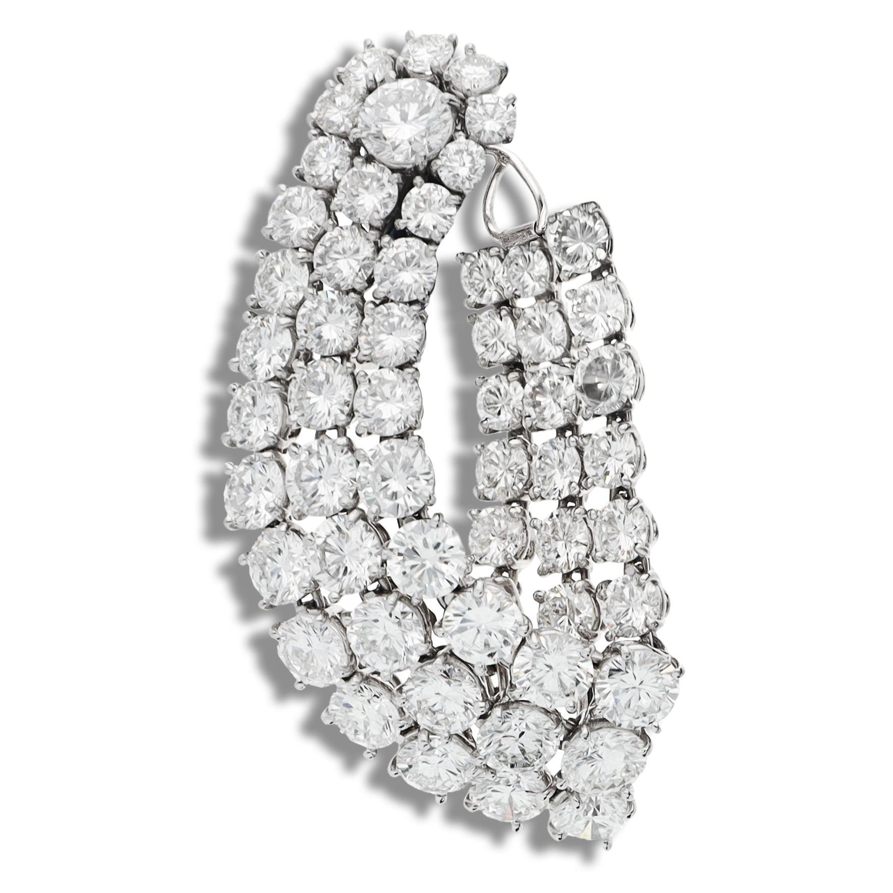 Stunning earrings featuring 106 prong-set round brilliant-cut diamonds arranged in three flexible rows, gracefully sweeping from the front of the ear to the back, measuring approximately 3.10mm at the smallest and approximately 5.60mm at the
