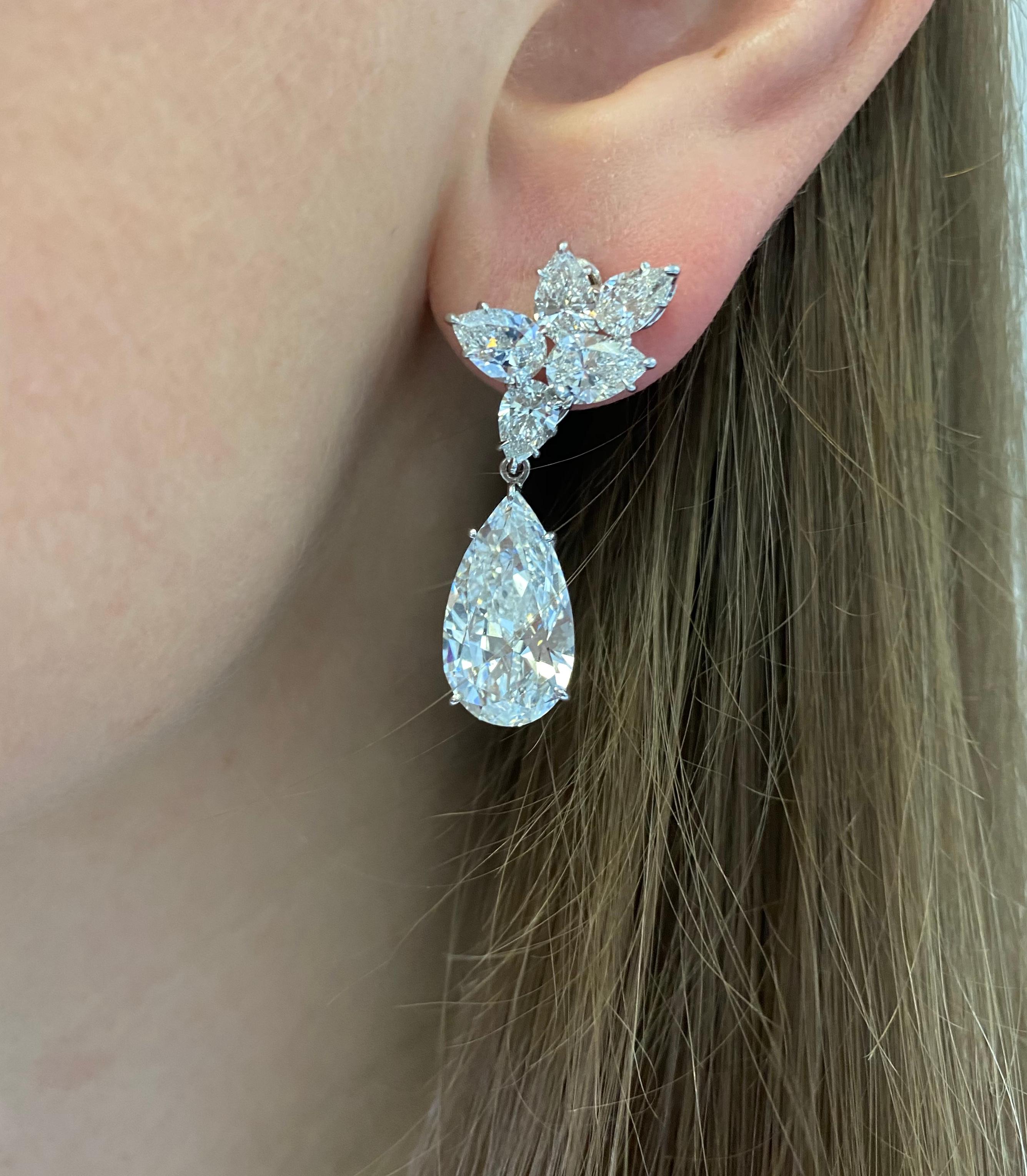 Platinum And Diamond Pendant Earrings By Harry Winston. 
Set With Two Pear-Shaped Diamonds
 5.56ct, D- VS2 GIA # XXXXXX )
5.05ct, D-VS2 (GIA # XXXXXX) 
Suspended By Clusters Of 12 Pear- Shaped Diamonds Weighing Approx. 5.00carat Color: E-F, Clarity: