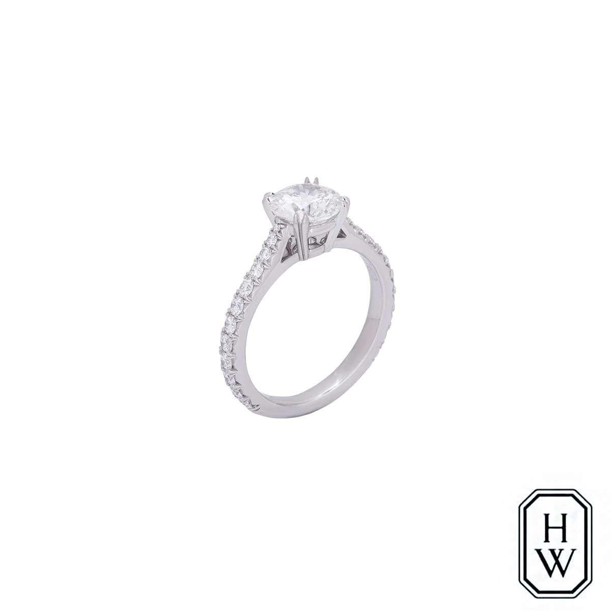 A stunning platinum diamond ring from the Brilliant Love collection by Harry Winston. The central double claw set diamond weighs 1.09ct, is E colour, VS1 in clarity and scores an excellent rating in all three aspects for cut, polish and symmetry -