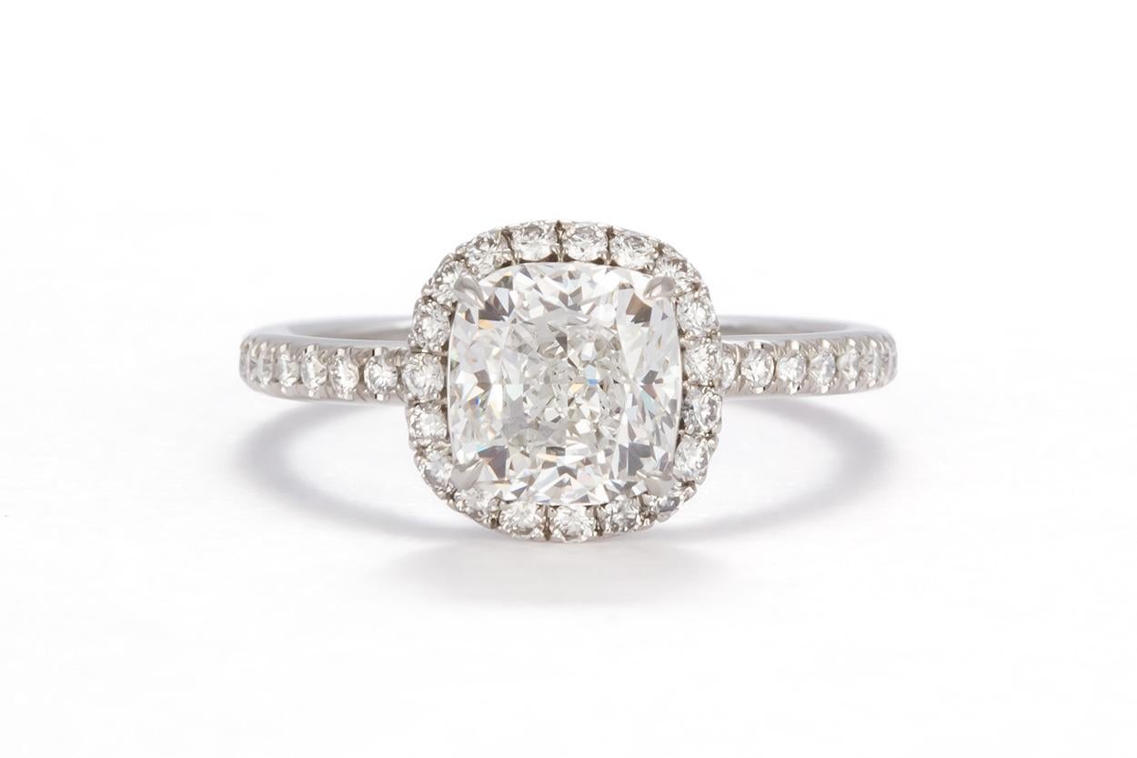 We are pleased to present this truly remarkable Harry Winston Platinum Cushion Cut Diamond Halo Engagement Ring. This stunning ring features a GIA Certified 1.51ct F/VS2 Cushion Modified Brilliant Cut Diamond set in a Harry Winston Platinum Halo
