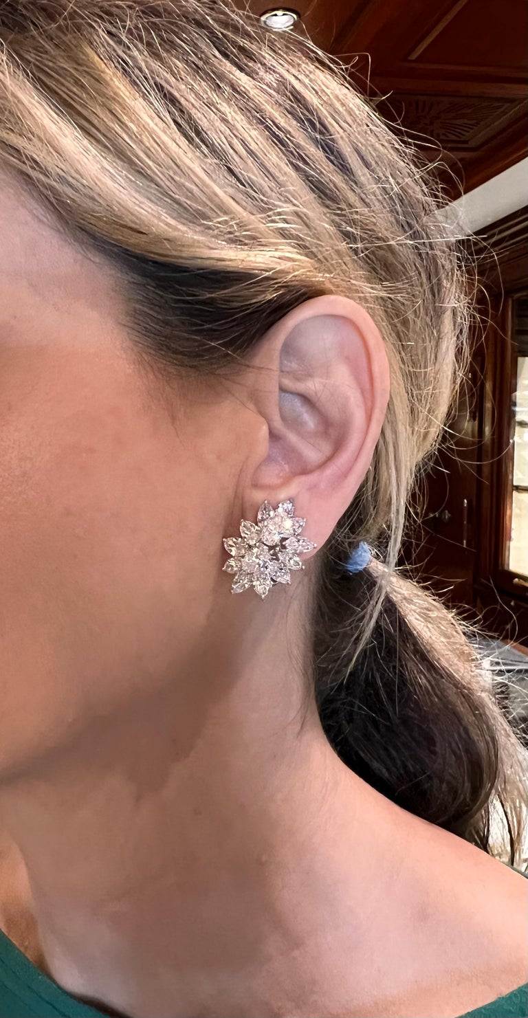 Elegant platinum and diamond cluster earrings by Harry Winston, set with twenty-two marquise and four pear brilliant-cut diamonds altogether weighing approximately 19.50 total carats (F-G color and VVS-VS clarity).  Hidden platinum wire enabling the