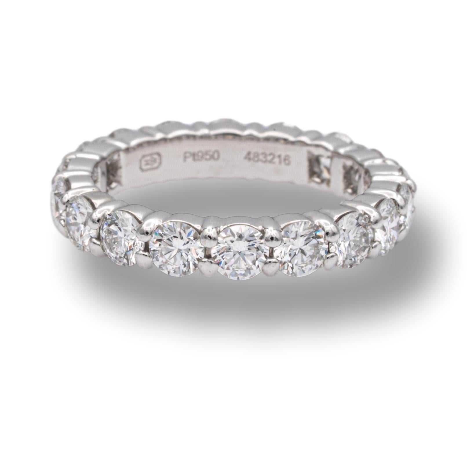 Harry Winston Diamond Eternity Anniversary band ring finely crafted in platinum with 18 round brilliant cut diamonds set in continuous shared prongs ranging D-F in color and VS2 and finer clarity.
Comes in Harry Winston pouch and box. 

Diamonds: