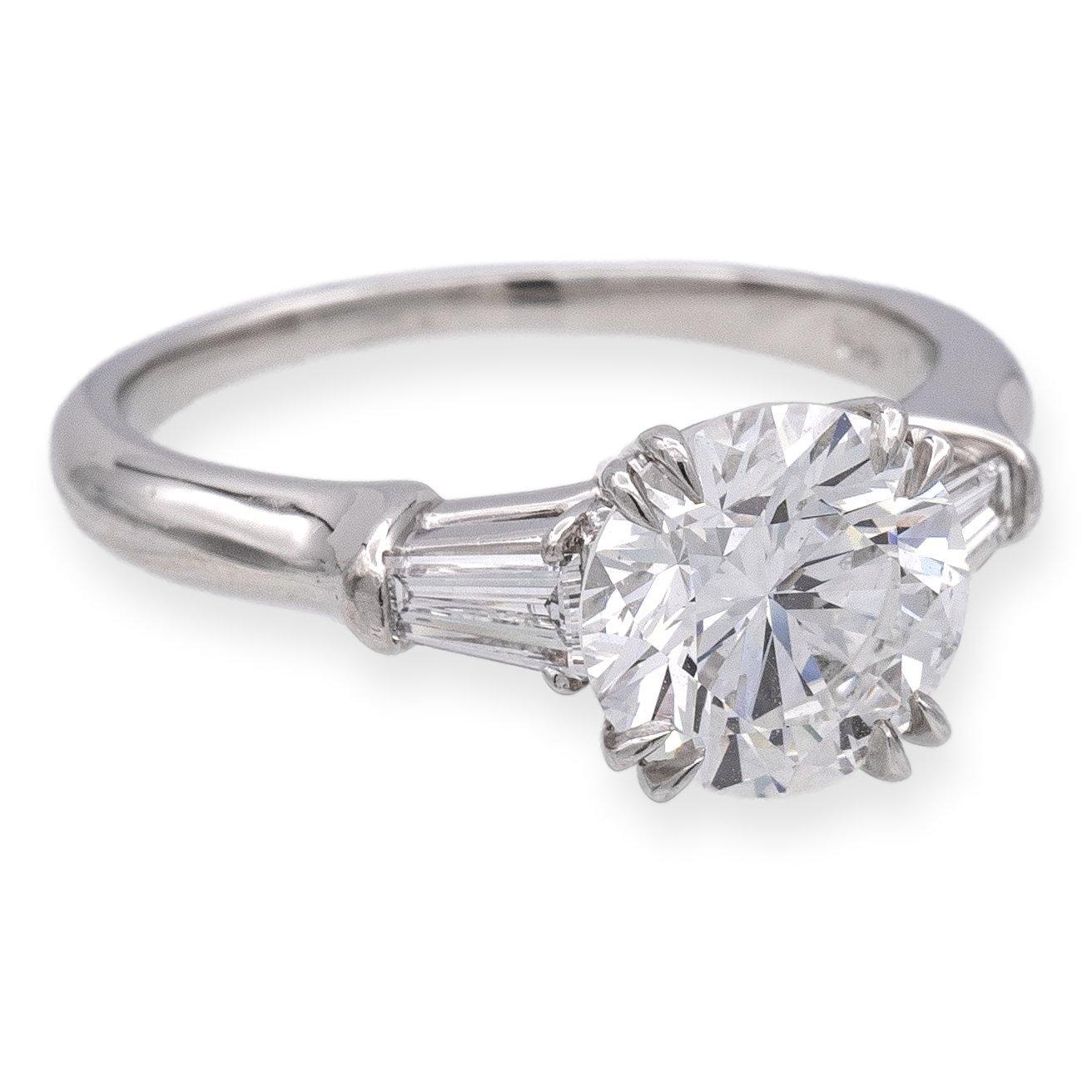 Harry Winston Solitaire Diamond Engagement ring from the classic collection finely crafted in platinum with a fine GIA Certified round center diamond set in double claw prongs weighing 1.77 carats, F color VS1 clarity . This Harry Winston ring