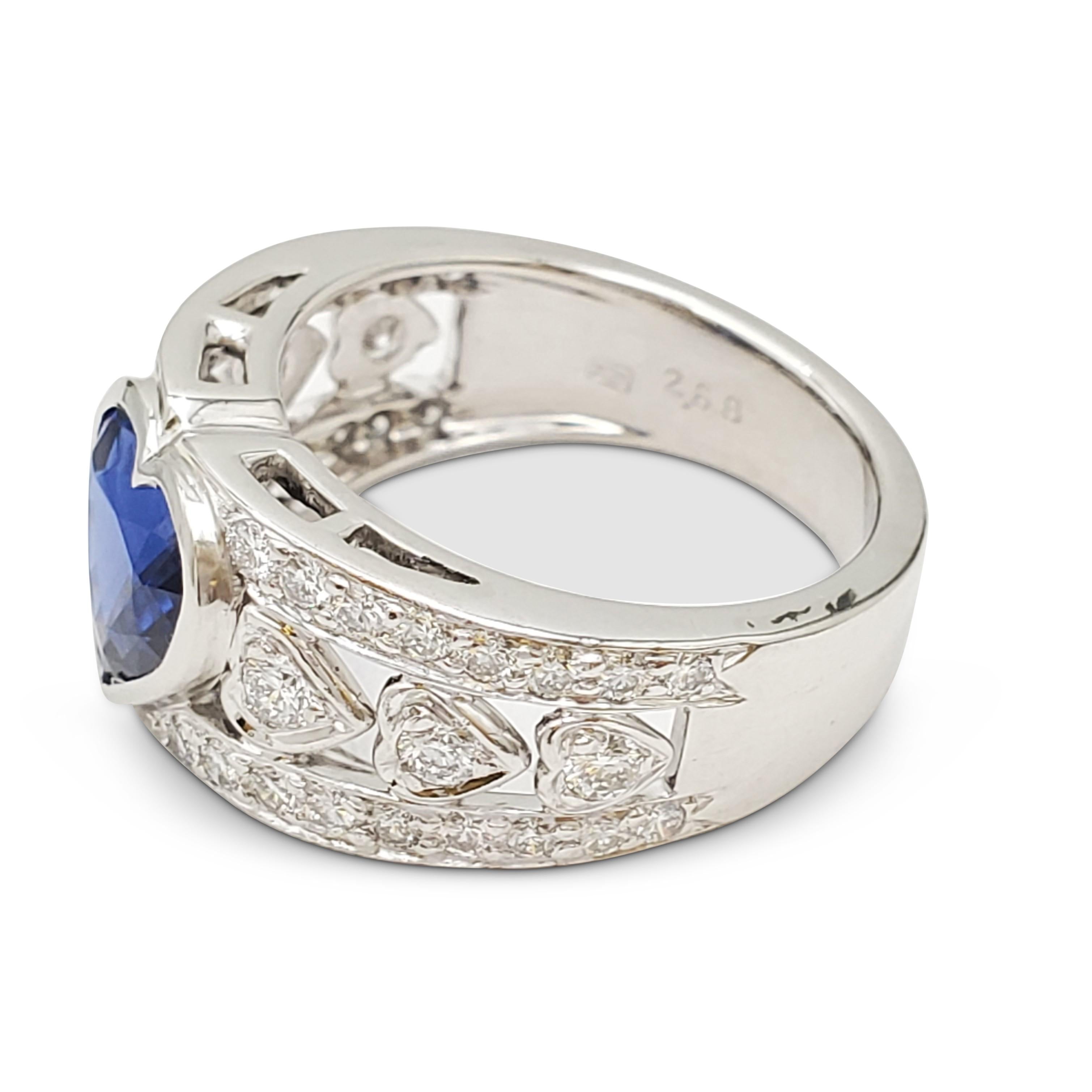 Authentic Harry Winston ring crafted in platinum centering on a heart-shaped sapphire weighing 2.65 carats. The openwork band is set with high-quality round brilliant cut diamonds weighing an estimated 0.78 carats total weight. Signed HW, PT950.
