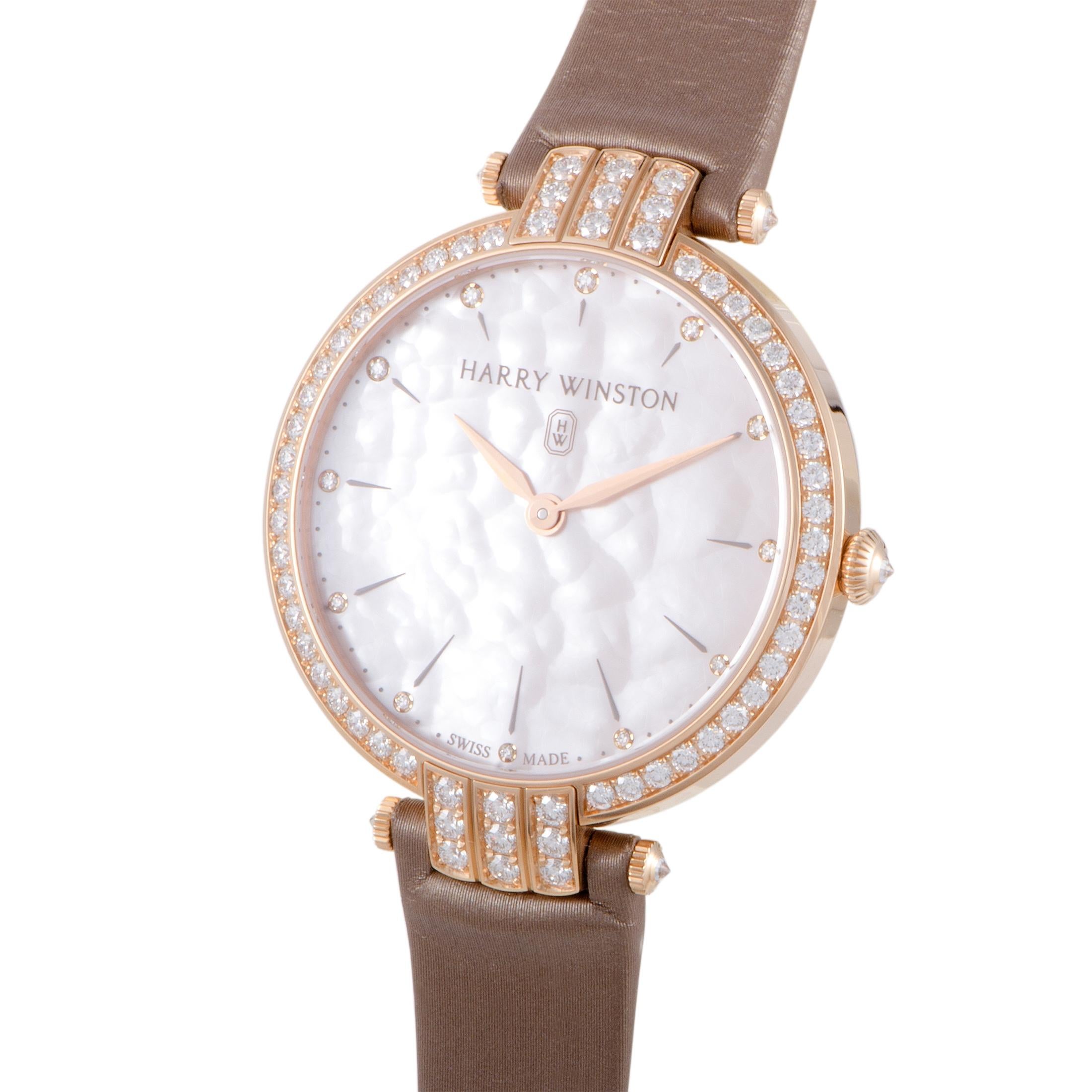 Delightful femininity, graceful elegance, and prestigious resplendence meet in this enchanting timepiece from Harry Winston which entices with its wonderful harmony of colors, fabulous radiance of gold, and tantalizing luster of diamonds. Driven by