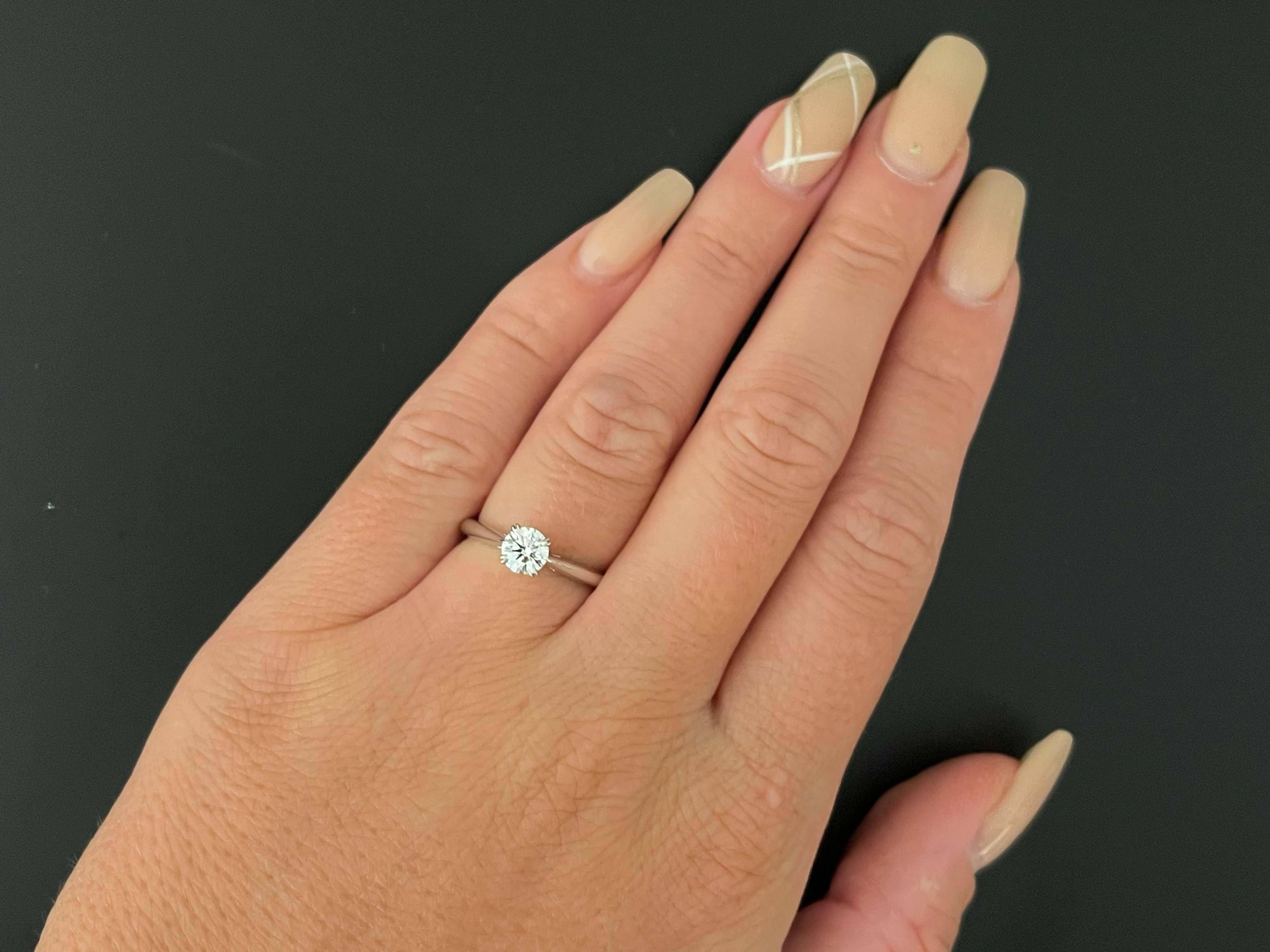 Harry Winston Solitaire Diamond Engagement Ring in Platinum features a round brilliant cut diamond D color, VS clarity weighing 0.57 carats. The diamond has excellent cut, symmetry and polish. An enduring emblem of commitment and love, Harry Winston