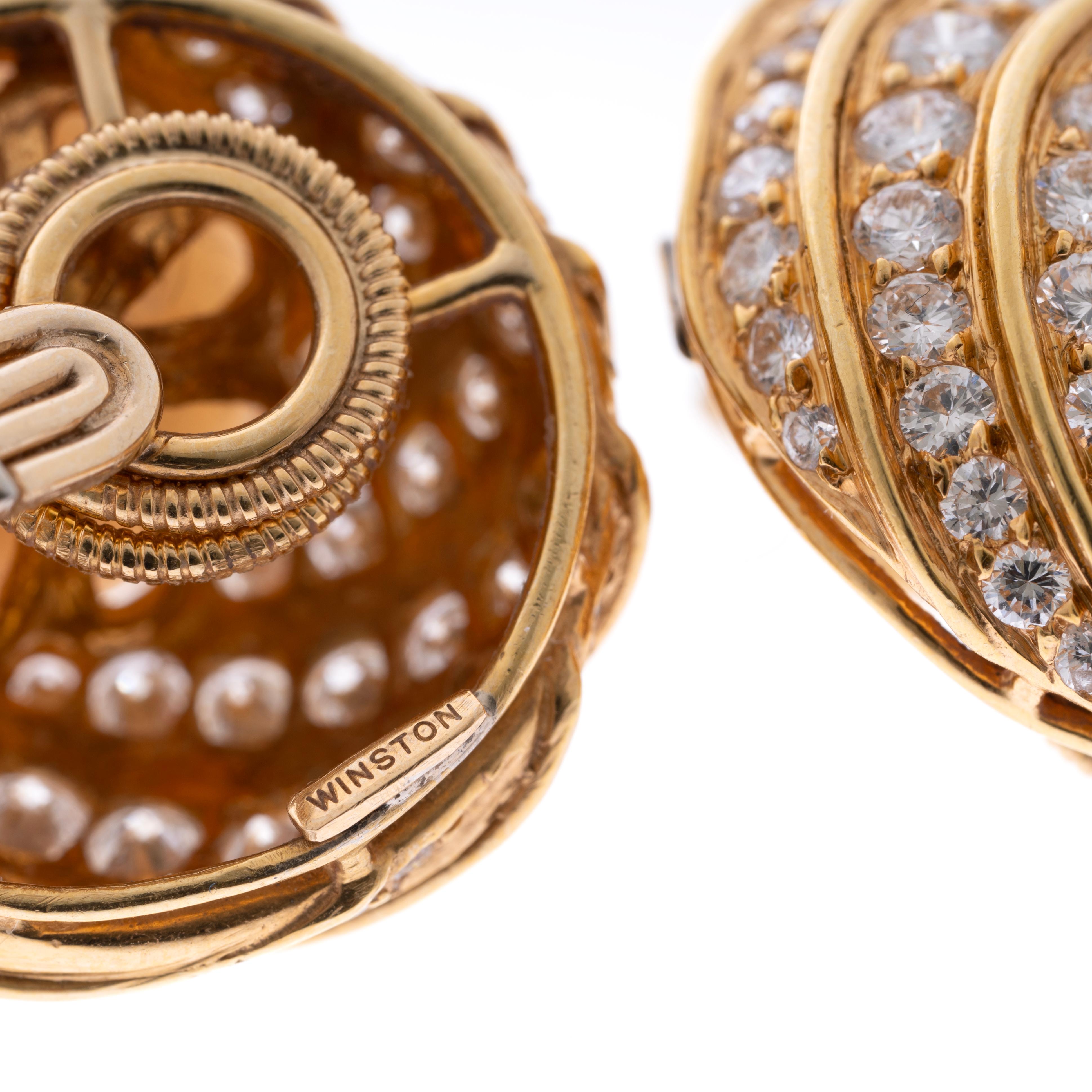 A stunning South Sea Pearl and diamond ear clips by Harry Winston. Designed as spirals of round diamonds weighing approximately 1.85 carats winding into the featured South Sea Pearls measuring 12mm each. Signed Winston, 18k yellow gold