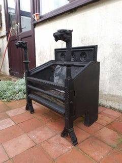 Hart Son & Peard, an English Aesthetic Movement Fire Grate with Dog Head Finials