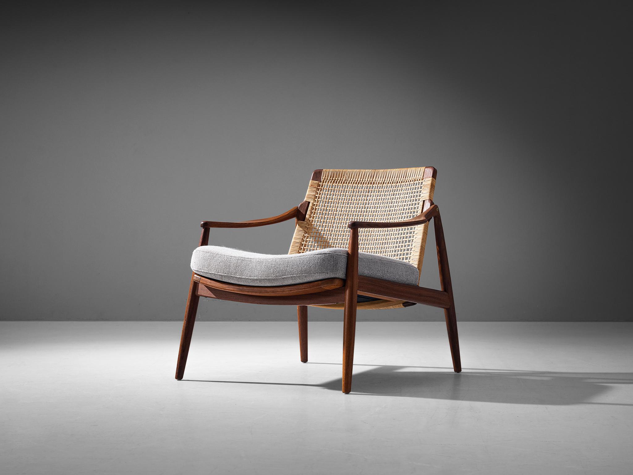 Hartmut Lohmeyer for Wilkhahn, lounge chair, teak, cane, fabric, Germany, 1960s

This lounge chair by Hartmut Lohmeyer is organically shaped. The wide open teak frame features a slightly tilted back made out of cane. The softly bent armrests and