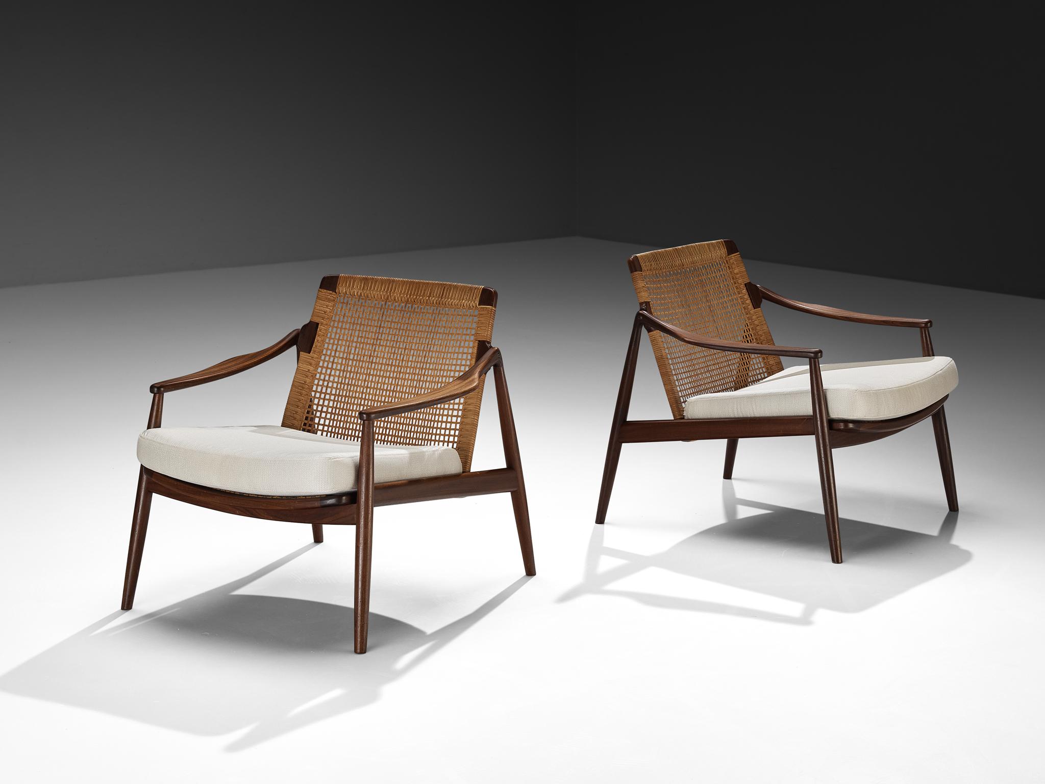 Hartmut Lohmeyer for Wilkhahn, pair of lounge chairs, teak, cane, fabric, Germany, 1962

This low reclining lounge chair, designed by Hartmut Lohmeyer, embodies a seamless blend of organic form and thoughtful craftsmanship. Its wide, open teak frame