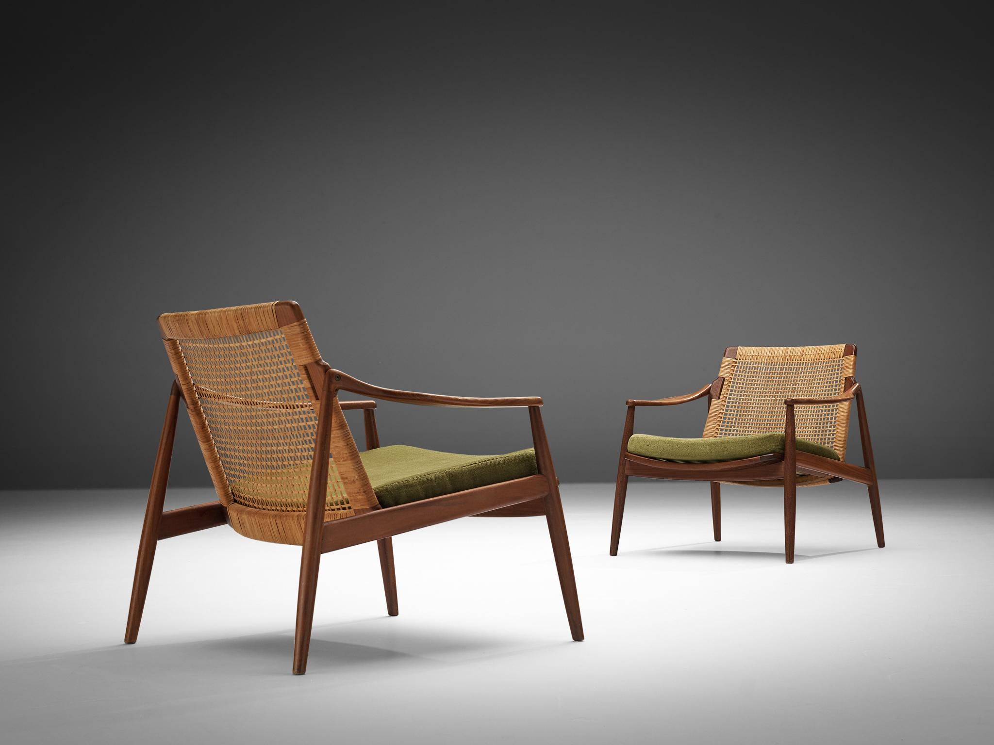 Hartmut Lohmeyer for Wilkhahn, pair of lounge chairs, teak, cane, fabric, Germany, 1962

These organically shaped lounge chairs by Hartmut Lohmeyer showcase a wide open wooden frame with a gentle tilt in the back, adorned with cane. The softly