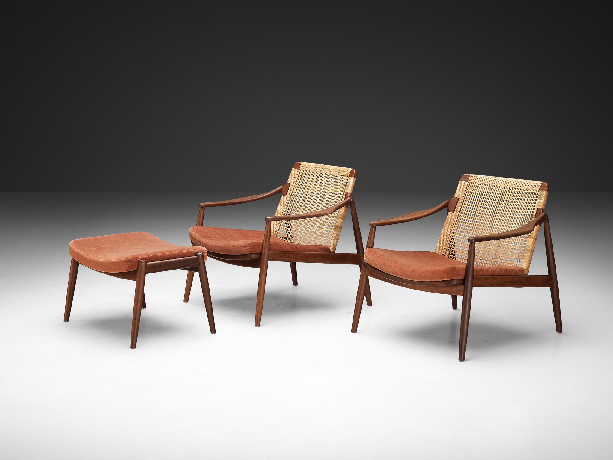 Hartmut Lohmeyer for Wilkhahn, pair of lounge chairs with ottoman, teak, cane, fabric, Germany, 1962

These organically shaped lounge chairs by Hartmut Lohmeyer showcase a wide open wooden frame with a gentle tilt in the back, adorned with cane. The