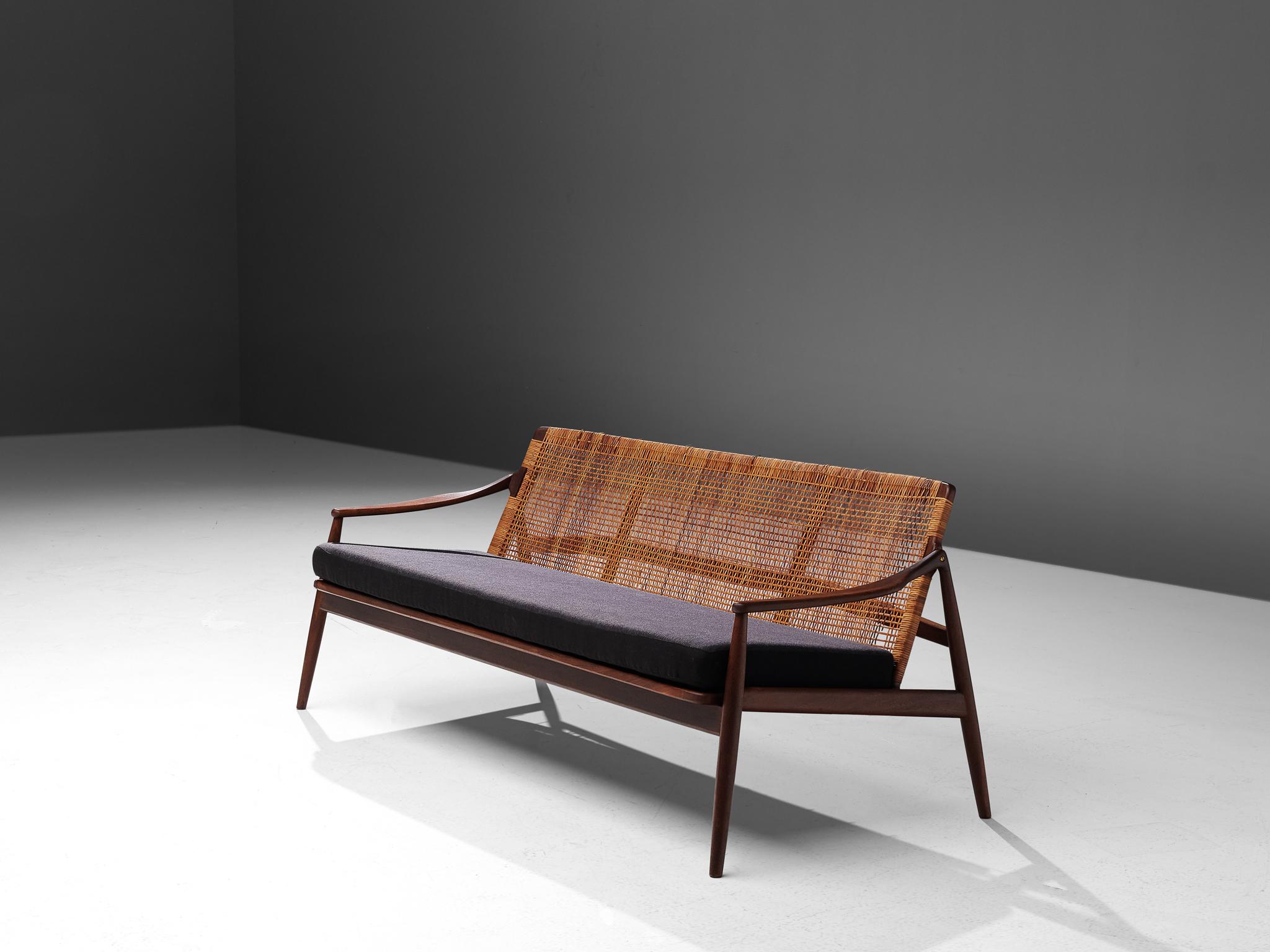 Hartmut Lohmeyer for Wilkhahn, sofa, fabric, teak and rattan, Germany, 1956

The sofa-bench is sensuous and organically shaped. It features a slightly tilted back and is executed with tapered legs. The softly bent armrests and open frame create a