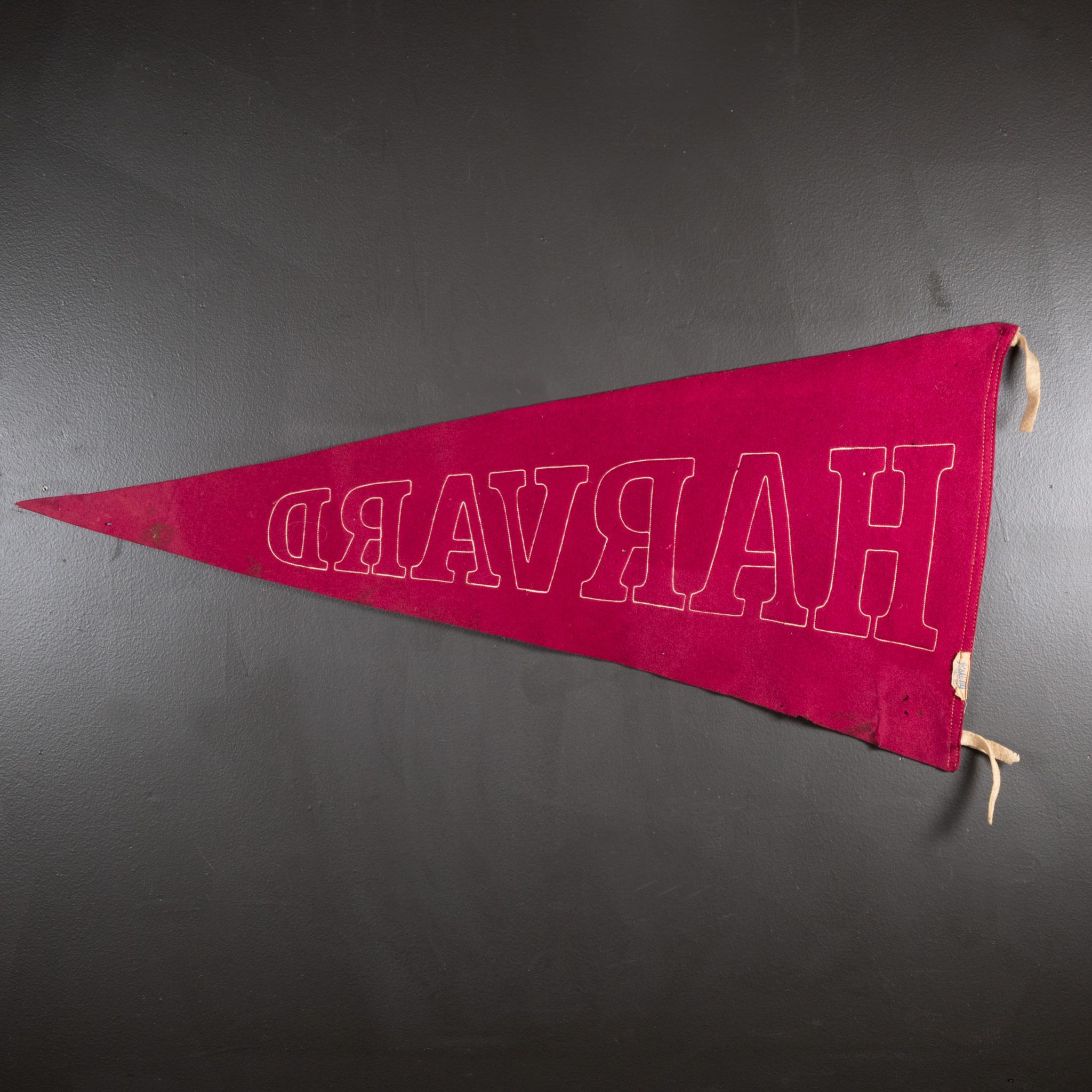 Vintage university pennant banner with sewn letters and tassels.

 CREATOR A & Co. New York, Wright & Ditson Athletic.
 DATE OF MANUFACTURE circa 1920-1940.
 MATERIALS AND TECHNIQUES Felt. 
 CONDITION Good. Wear consistent with age and use..