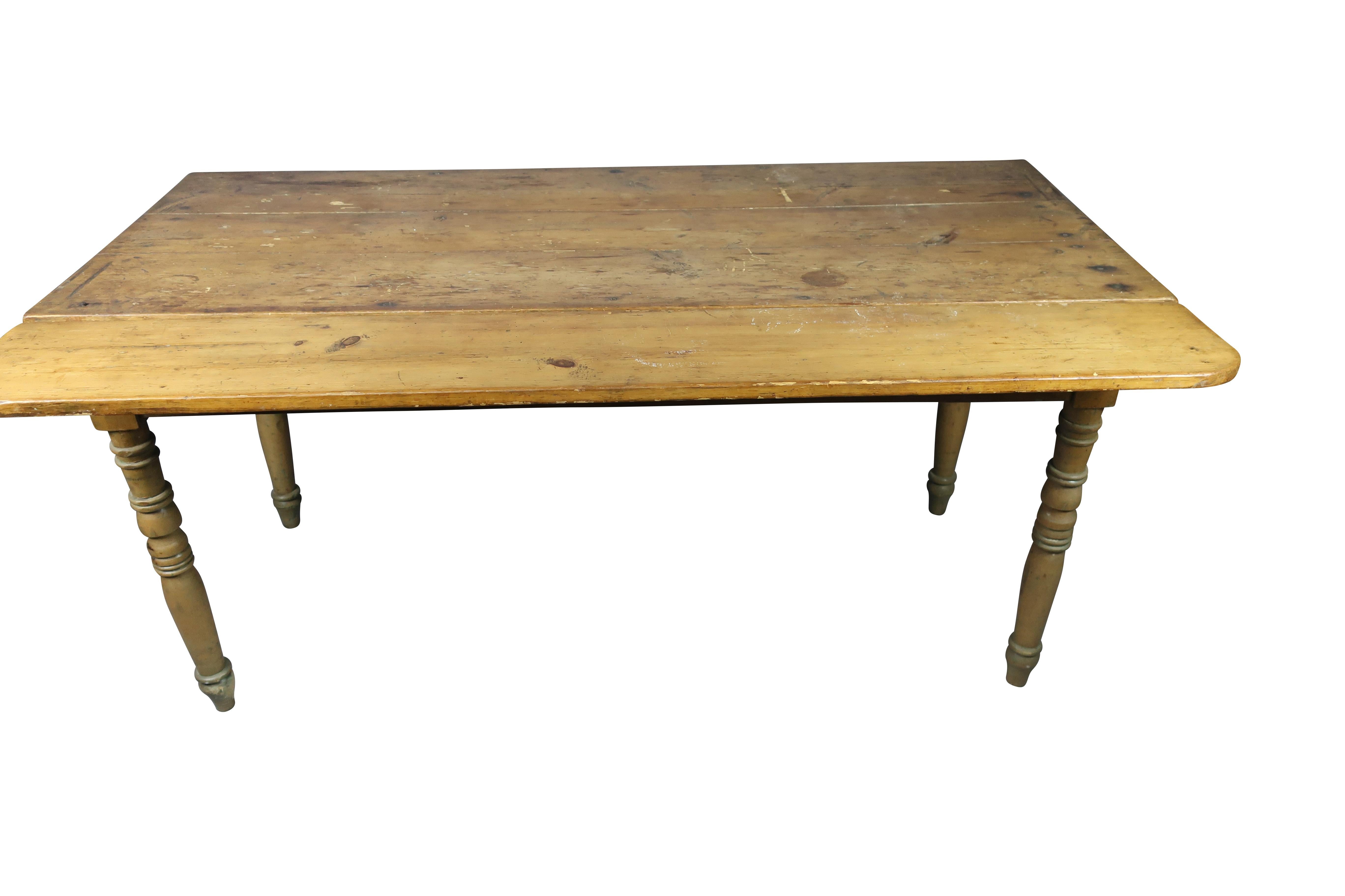 Farmhouse early pine drop-leaf harvest dining table, with two drop-leaf sides. Seats 6-8 comfortably. Great patina on the tabletop. Traces of original green paint on legs.