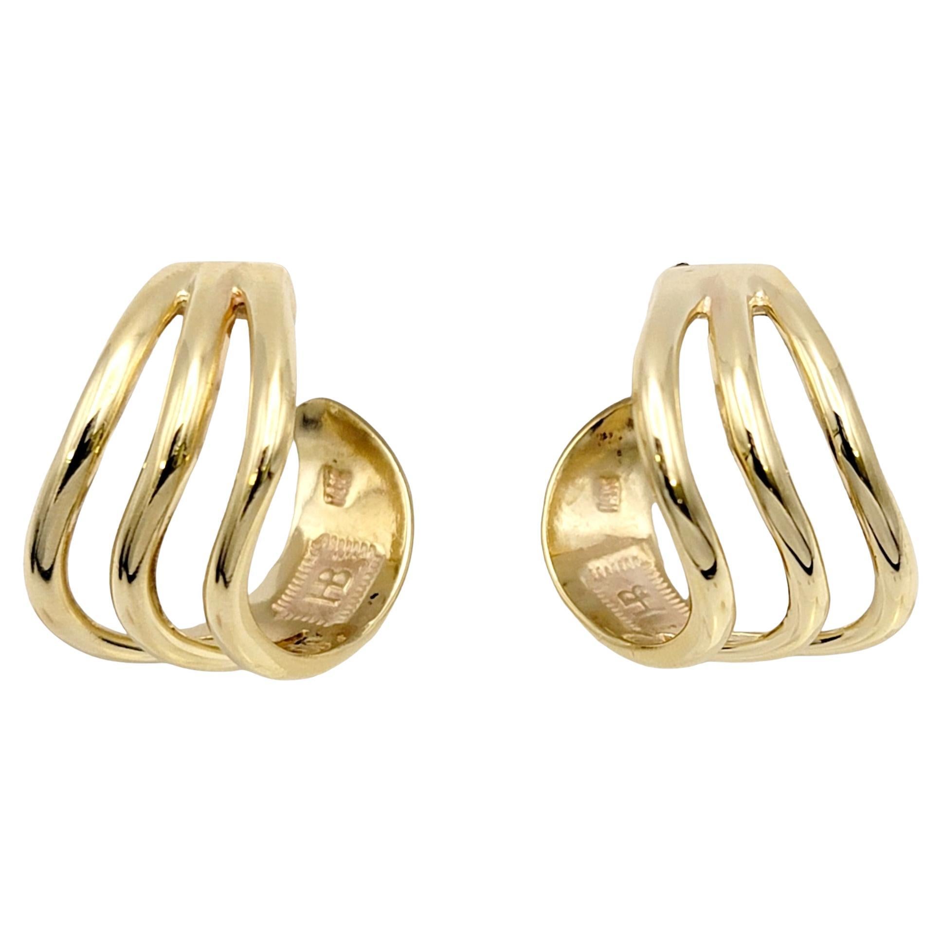 Simple yet stunning 14 karat yellow gold hoop earrings by Harvey Begay. These unique contoured hoops give off a stylish, modern vibe while gently hugging the lobe. You will adore these earrings! 

The sleek hoop style earrings features a triple