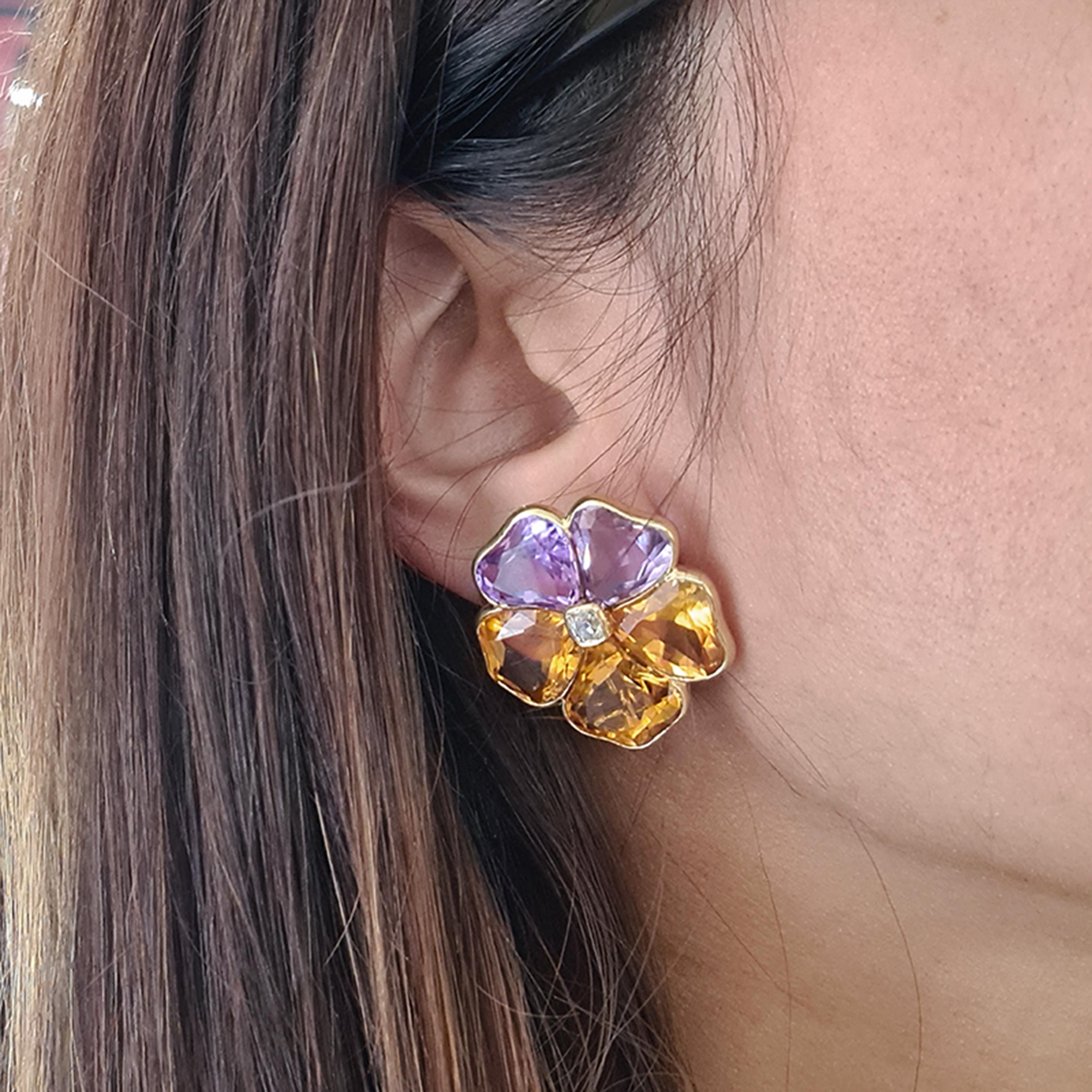 A pair of amethyst, citrine and diamond pansy earrings, with fancy cut amethysts forming the two upper petals and citrines representing the three lower petals, with the centre of each pansy set with a peruzzi-cut diamond, in rub over settings,