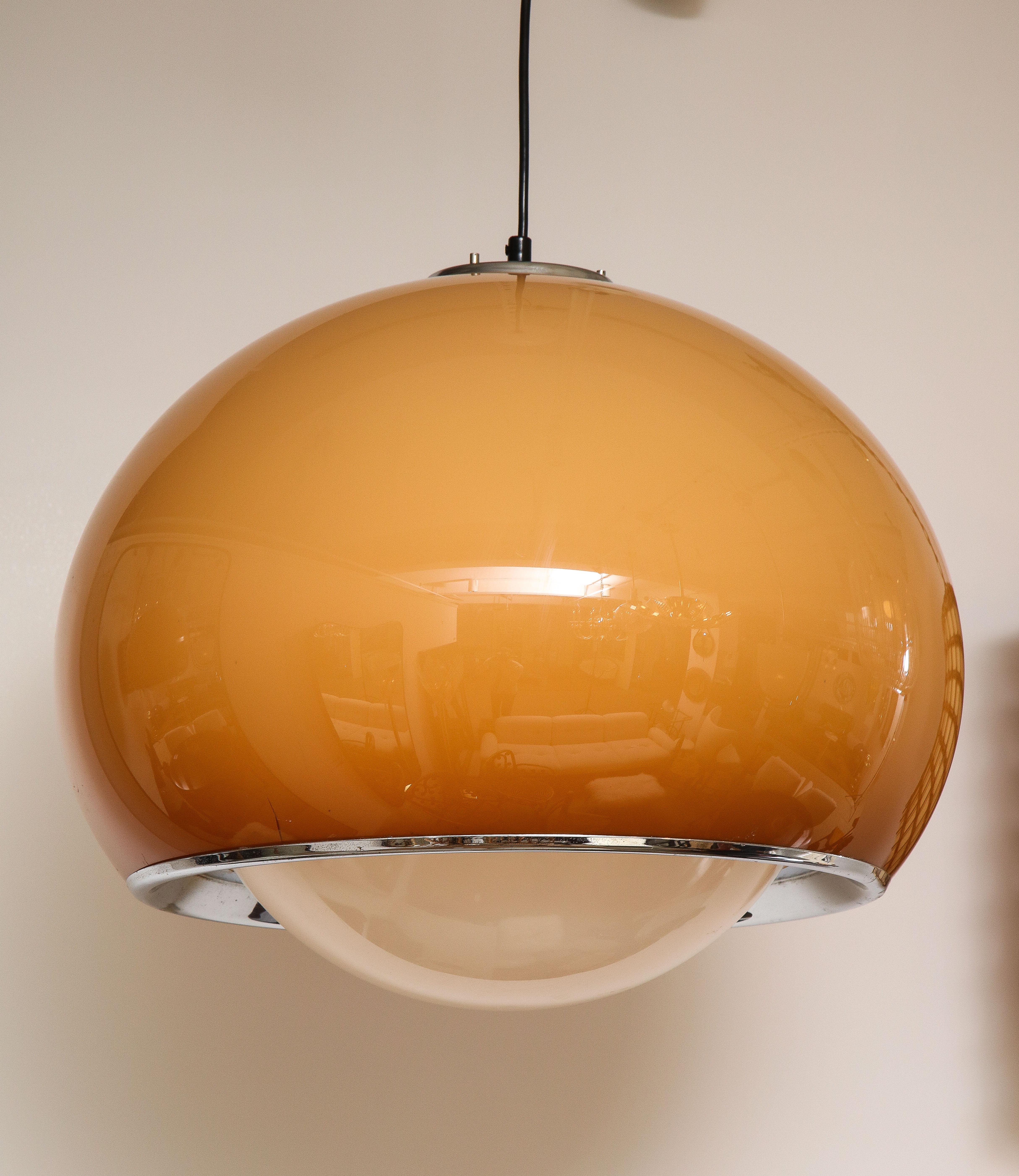 Harvey Guzzini chandelier in caramel/brown coloring, with an acrylic dome shape and original white acrylic canopy. The underside of the dome with chrome surround. Emits a beautiful warm light. Great statement piece and highly indicative of the